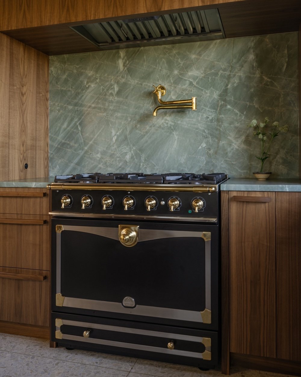 Black range with brass details and walnut cabinets.jpg