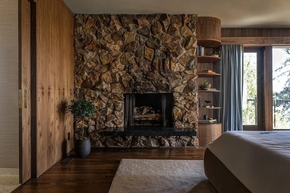 Midcentury modern primary bedroom with rock fireplace.jpg