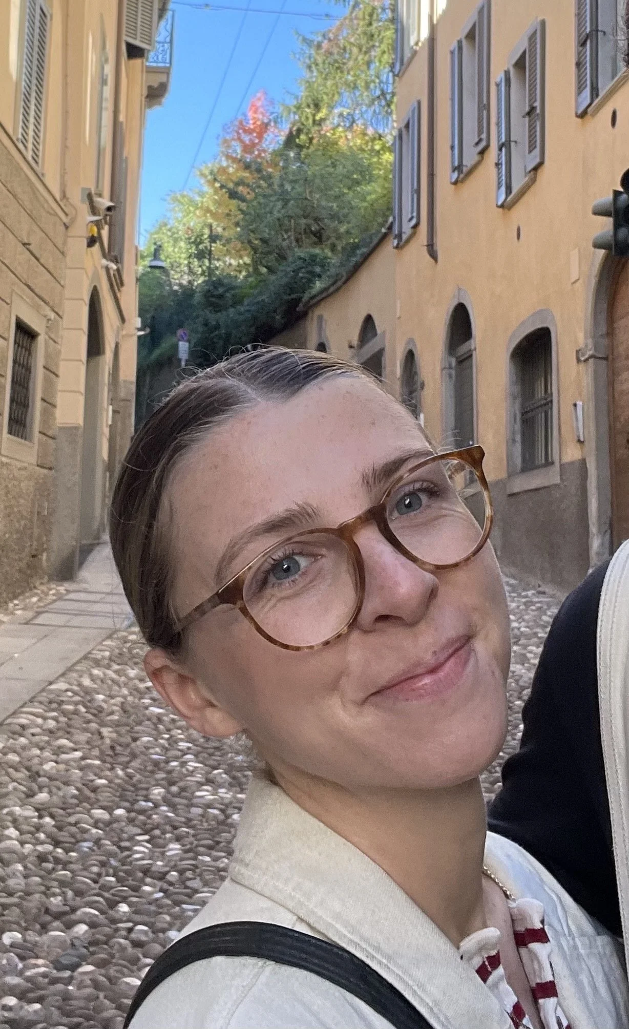A woman with glasses and blonde hair