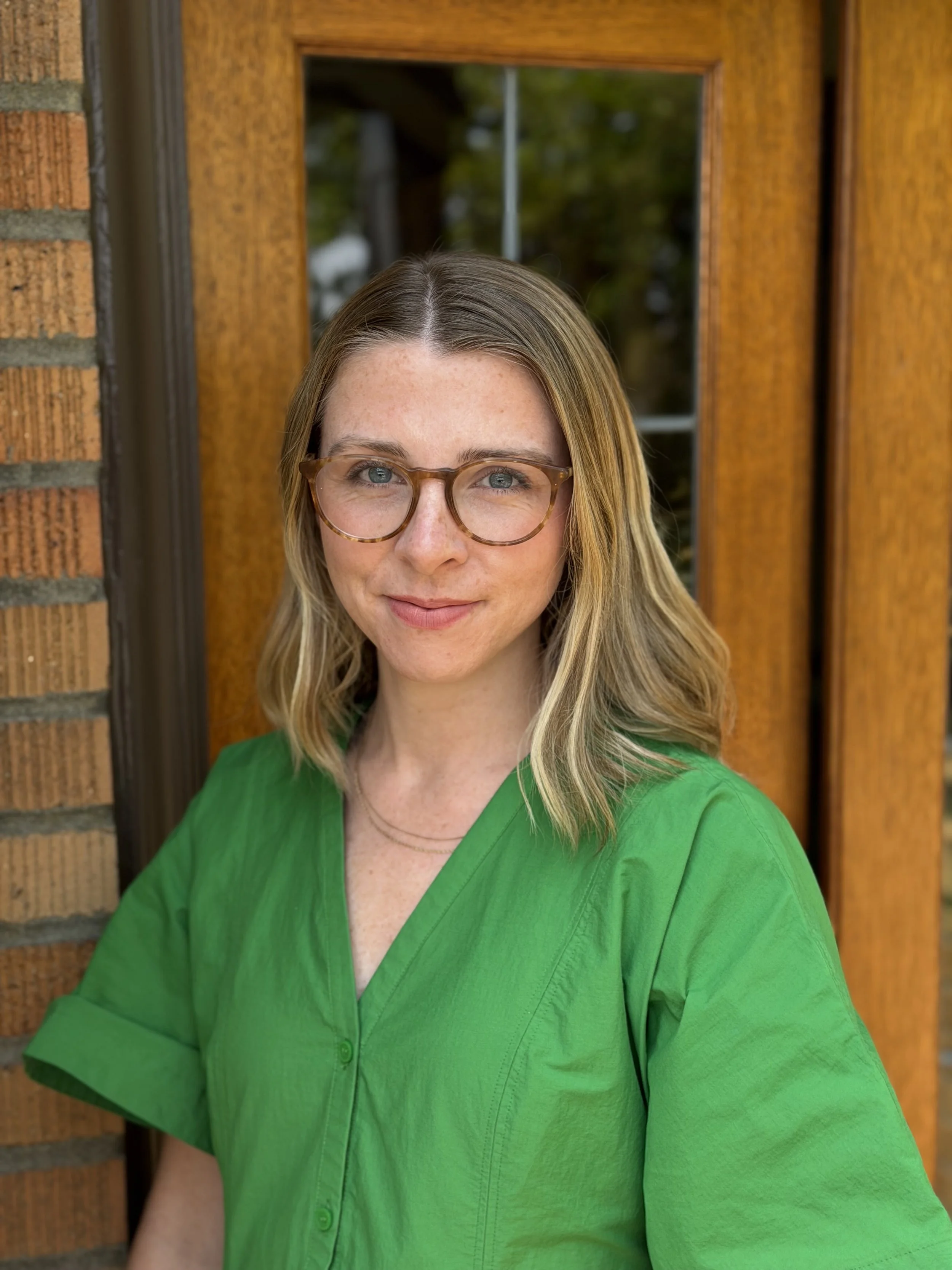 A woman with glasses and blonde hair