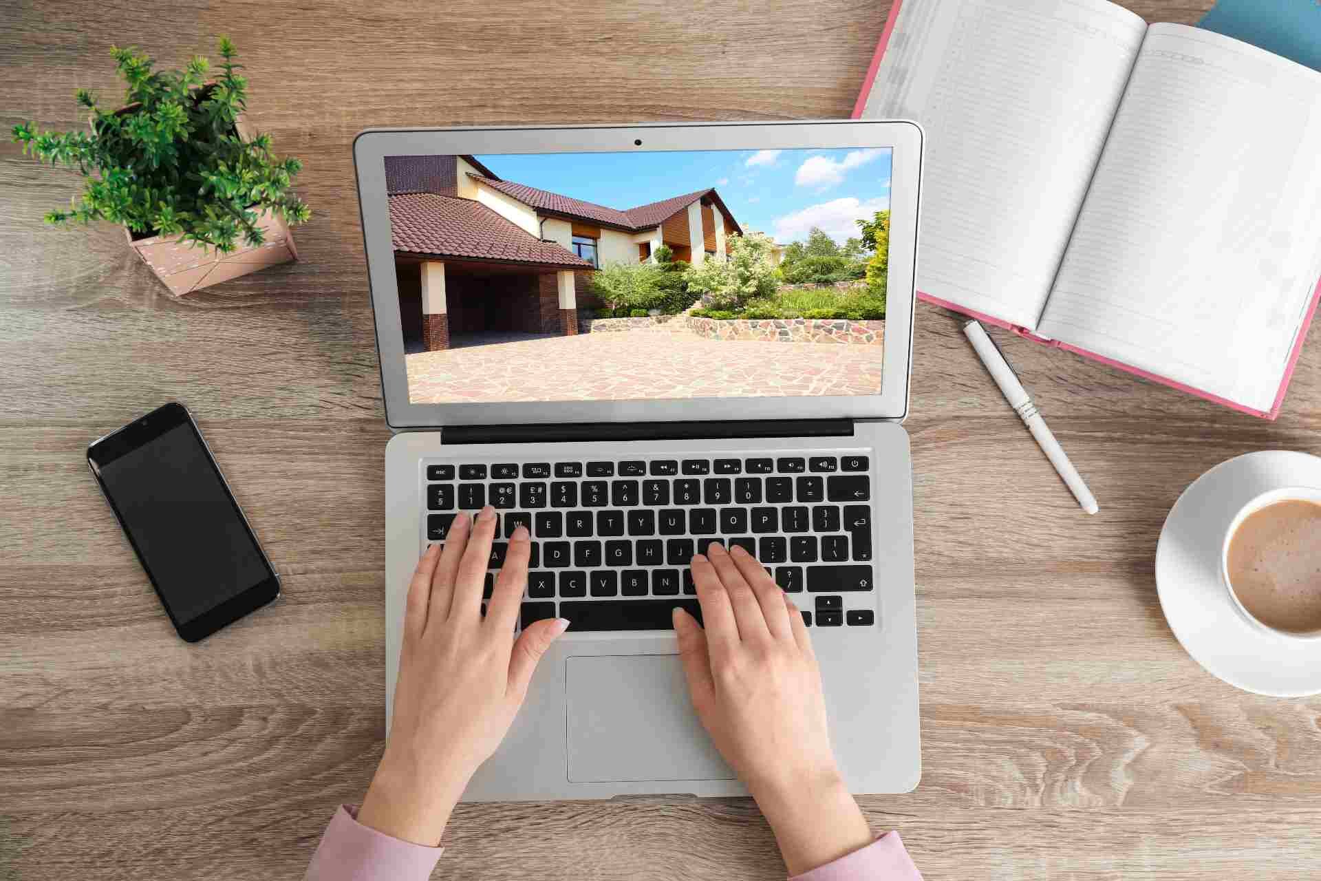 Woman_choosing_new_house_online_using_laptop.jpg