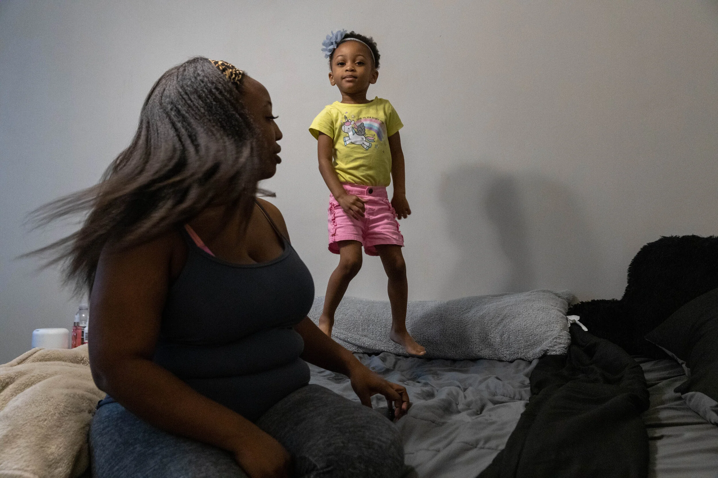 Essence Harrison watches her daughter Amiya Belton (3) jump on Harrison’s bed at their home in Charleston, South Carolina.
