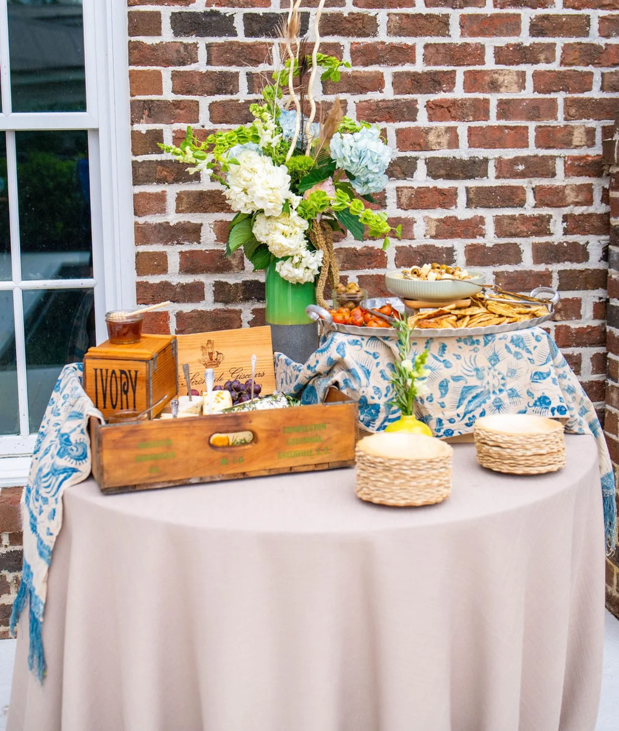 Luxury Charleston tablescape by Sweet Mae’s featuring vintage linens, triple cream brie, styled florals, and elevated coastal event design