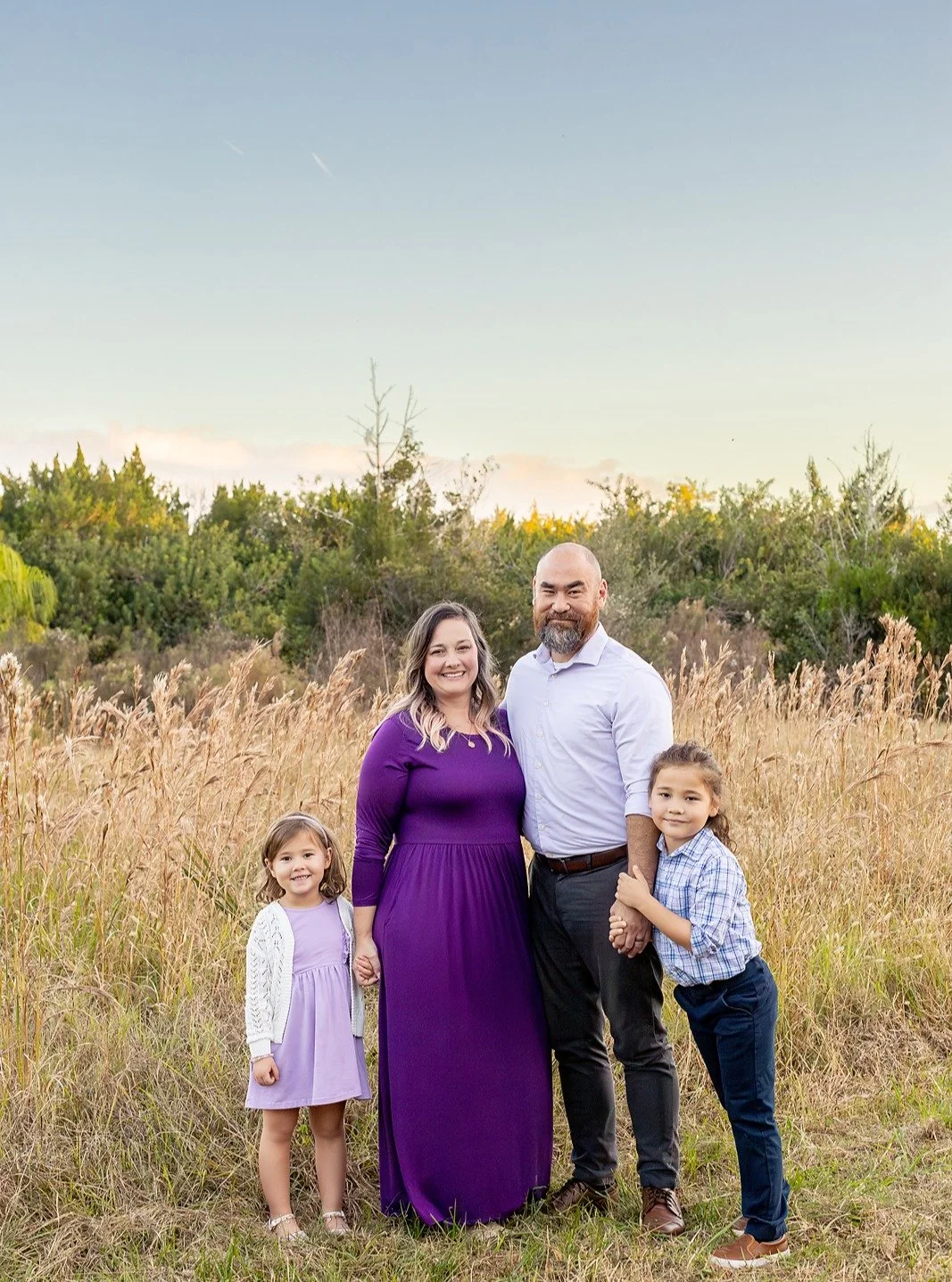 Golden hour, elevated.

This family chose a sunset field session with intention classic silhouettes, coordinated styling, and a bold pop of color that commands attention. Her purple dress didn&rsquo;t just complement the landscape&hellip; it anchored