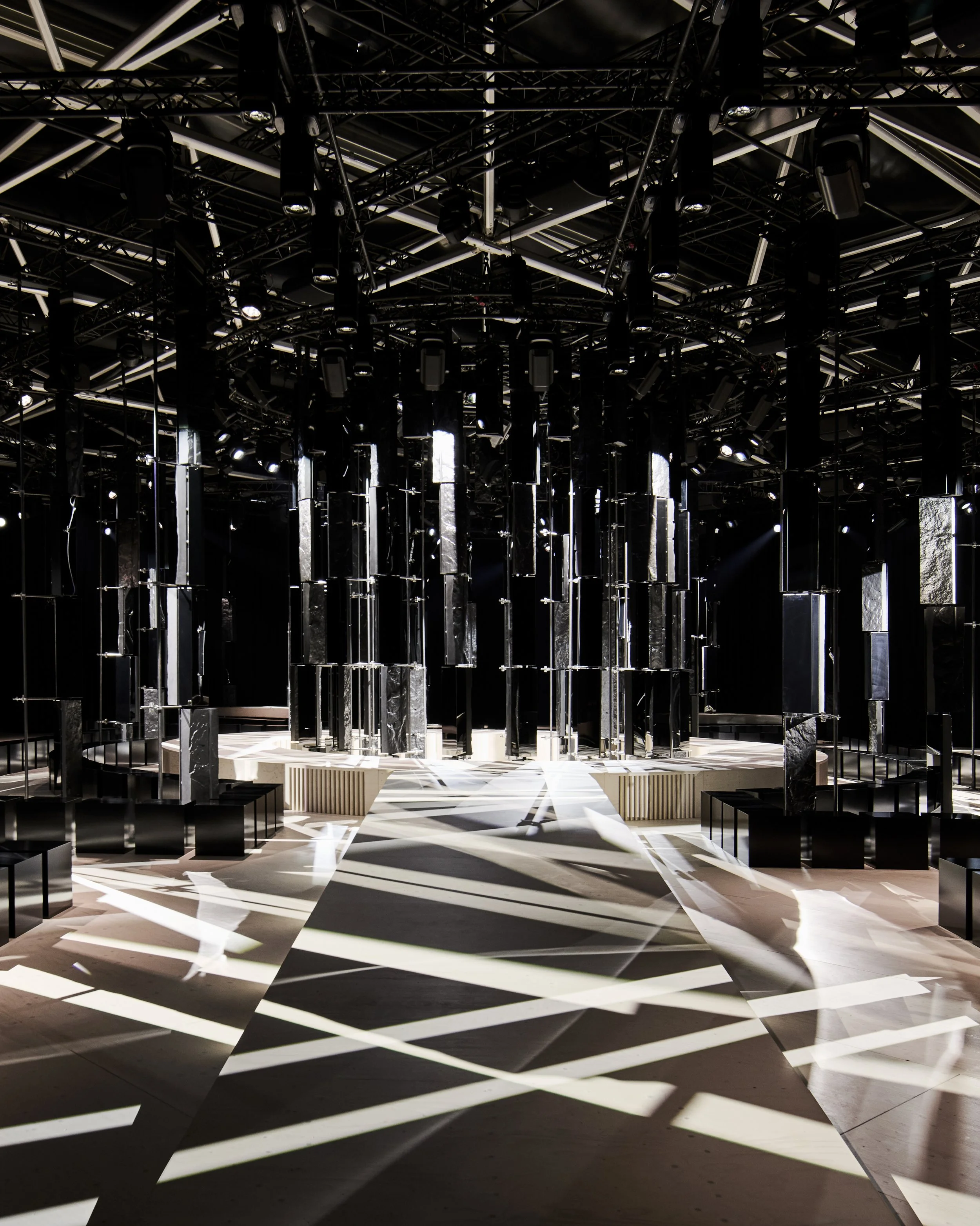 Runway with stripes of white light under a lighting grid, Givenchy Fall/Winter 2026 show, Sarah Burton