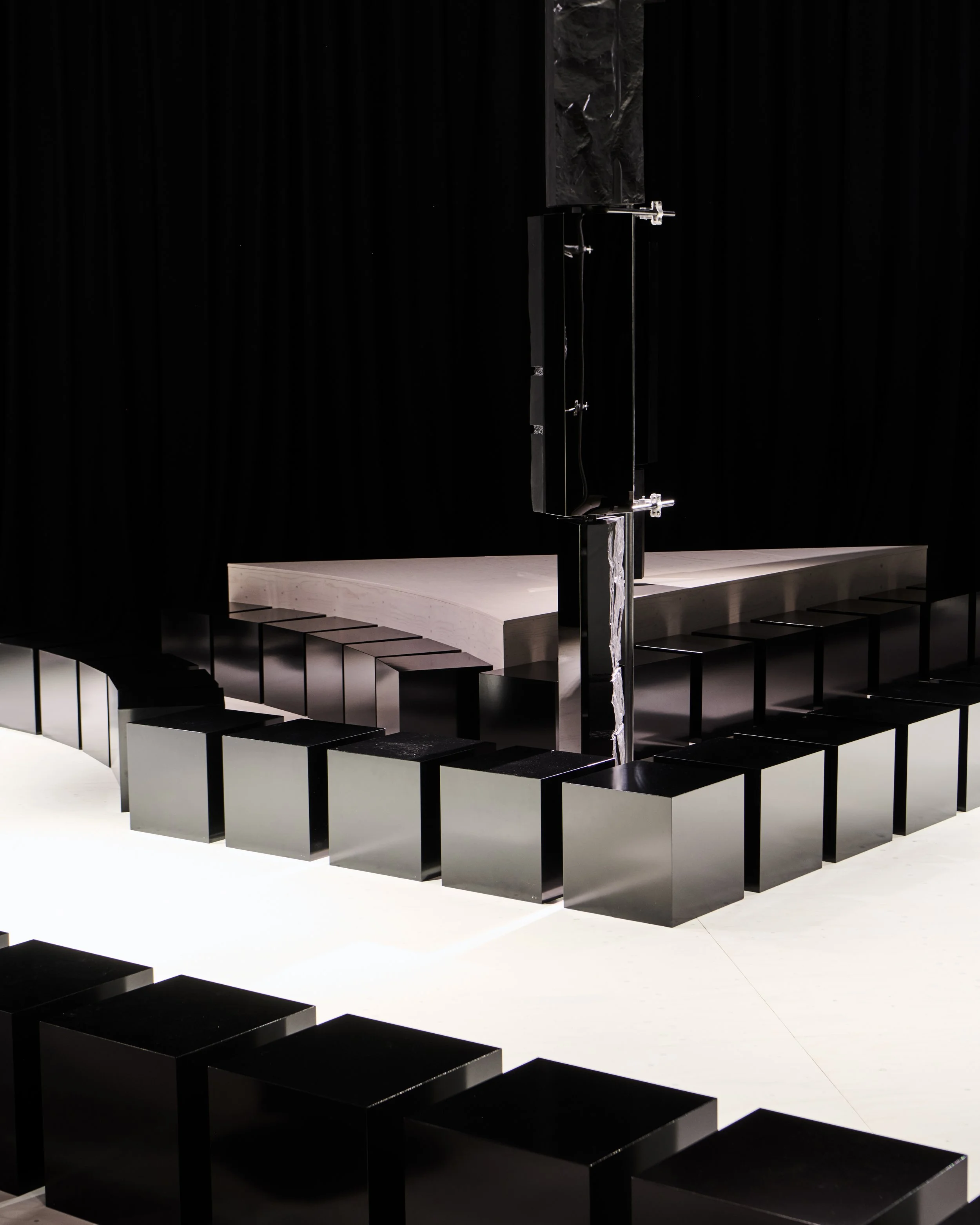 Raised runway platform with black block seating, Givenchy Fall/Winter 2026 show, Sarah Burton