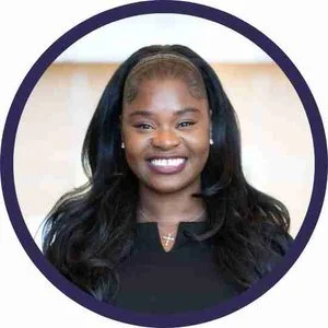 A smiling Black woman with long hair, showcasing her joyful expression and vibrant personality.