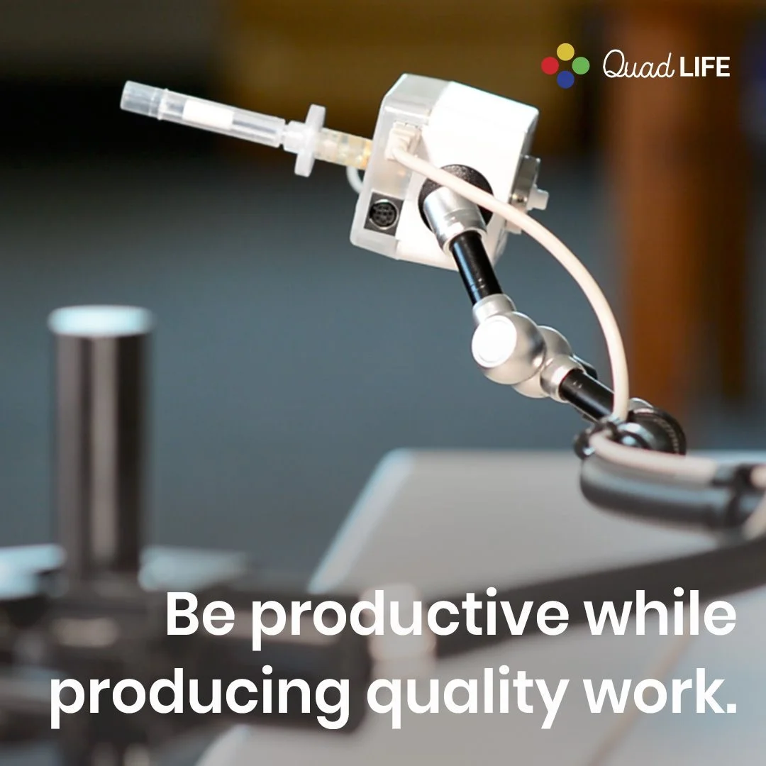 close-up of laboratory microscope with a focus on the eyepiece and objective lens, with blurred background and the text 'Be productive while producing quality work'.