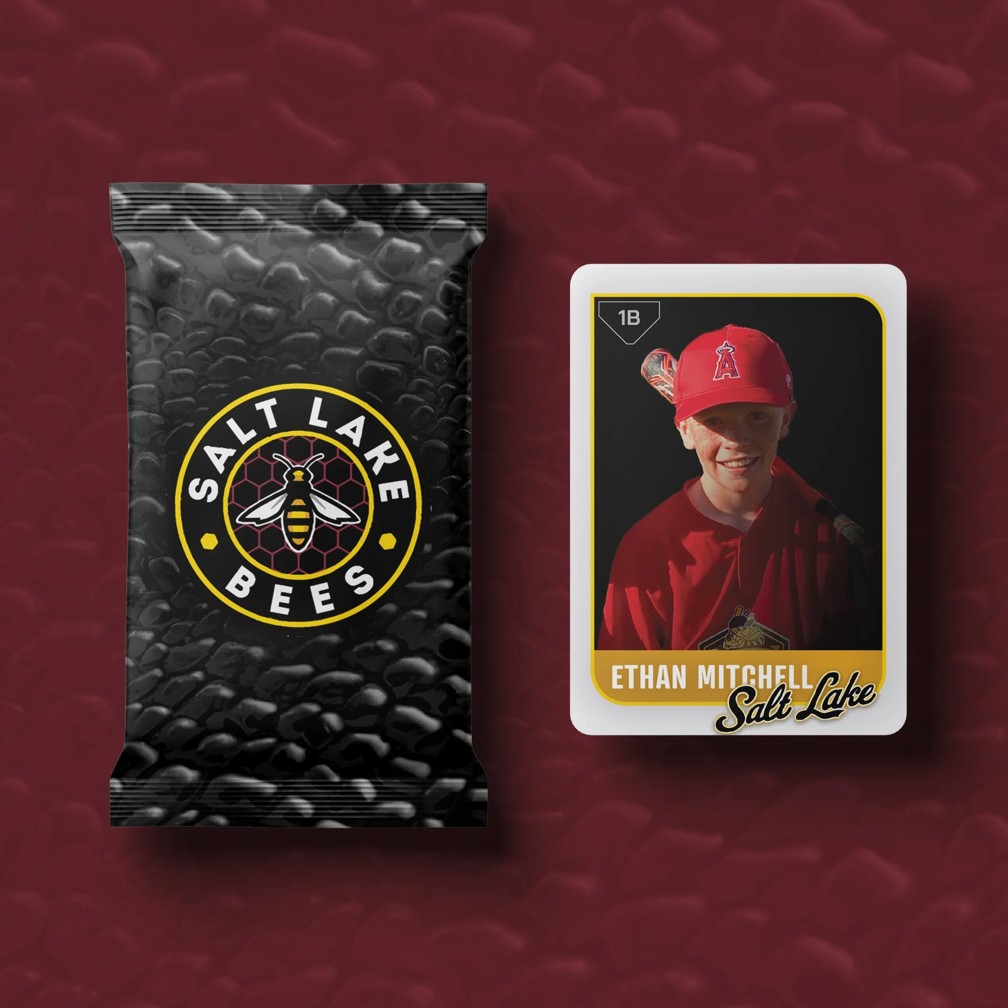 A Salt Lake Bees trading card featuring Ethan Mitchell, dressed in a red baseball uniform and cap with the team's logo, next to a black Salt Lake Bees snack bag with a bee logo, on a red textured background.