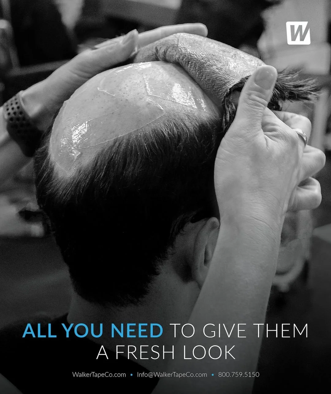 A person applying a fresh hair tape to the top of a man's head to give him a new, clean look at a salon.