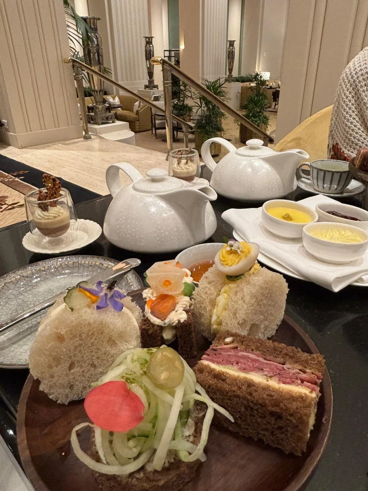 Afternoon tea with tea pots and tea sandwiches