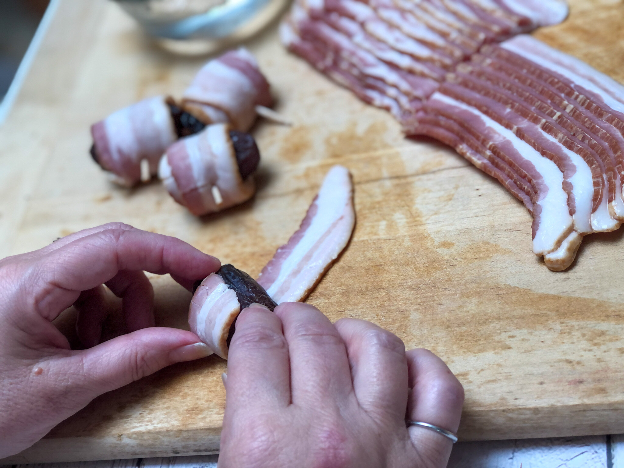 Rolling dates in bacon to make a super easy appetizer