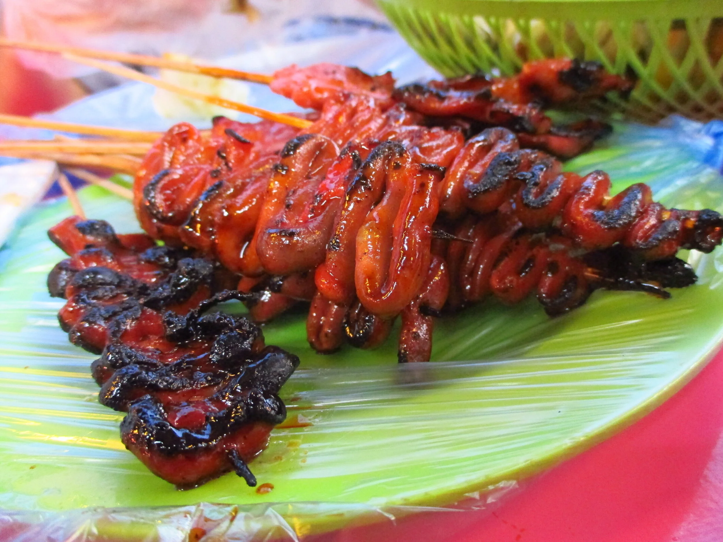 Skewers of the Filipino street food, Isaw, chicken tripe.