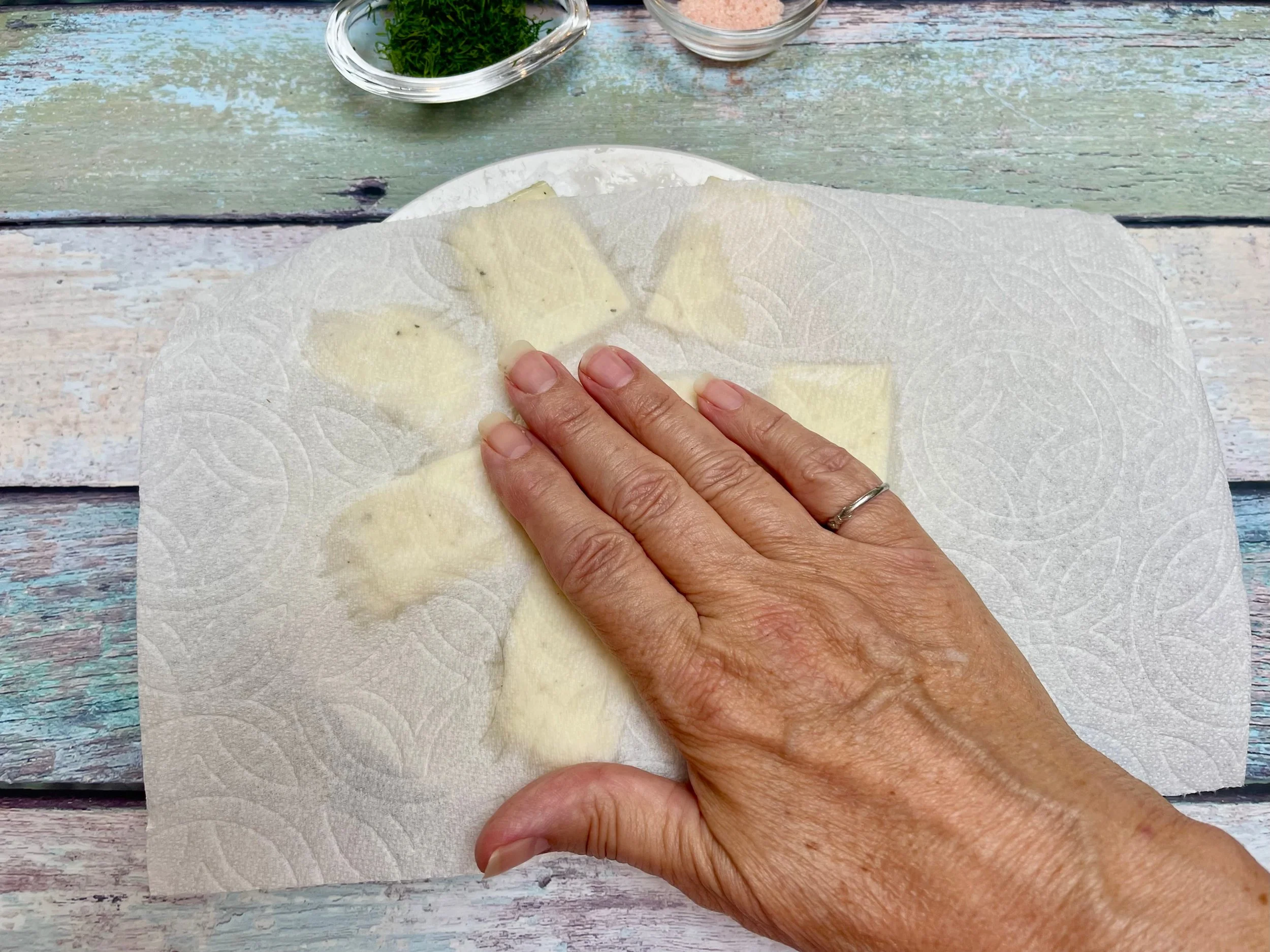 Patting Halloumi with paper towels
