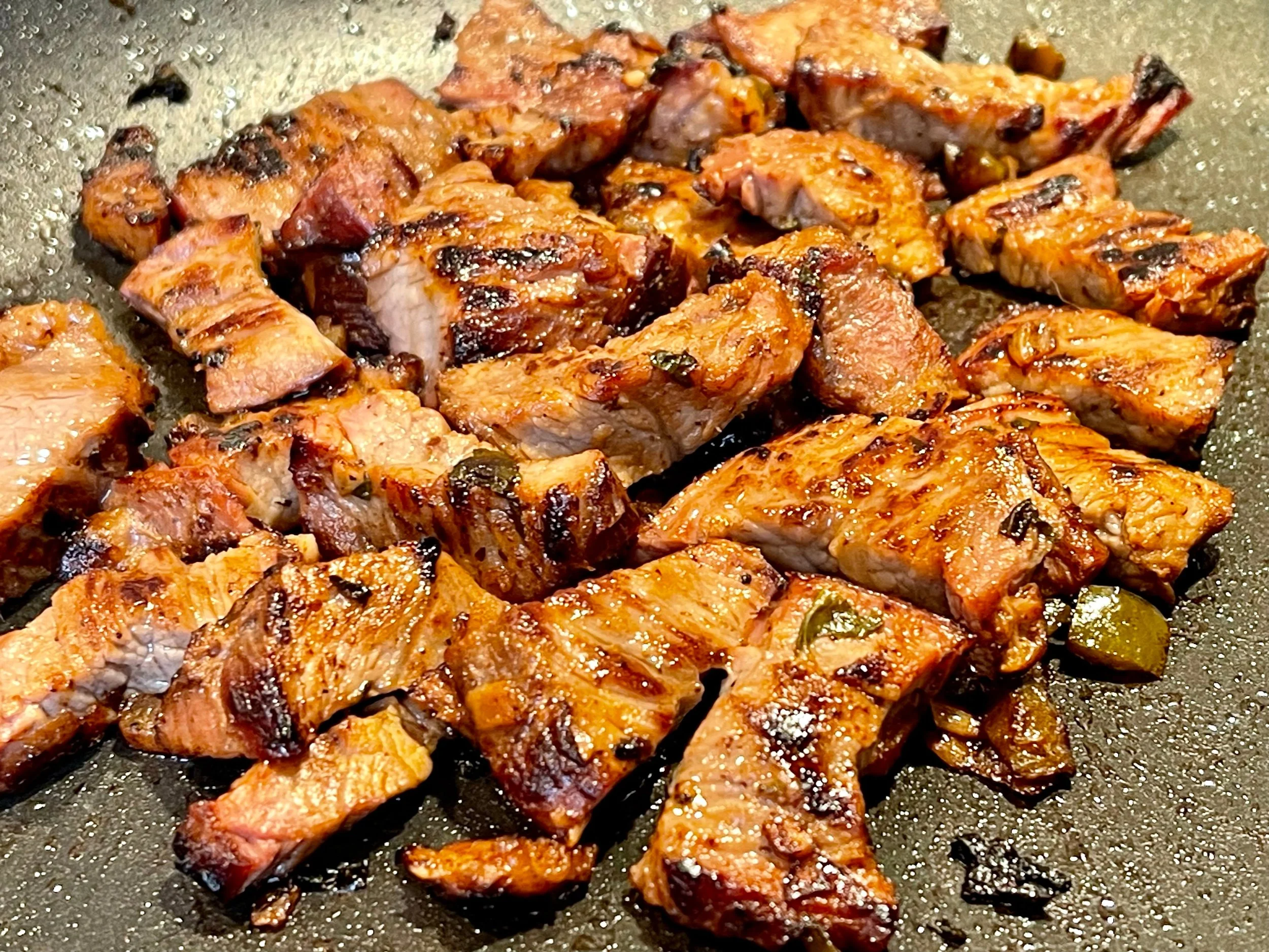 Searing the chopped carne asada