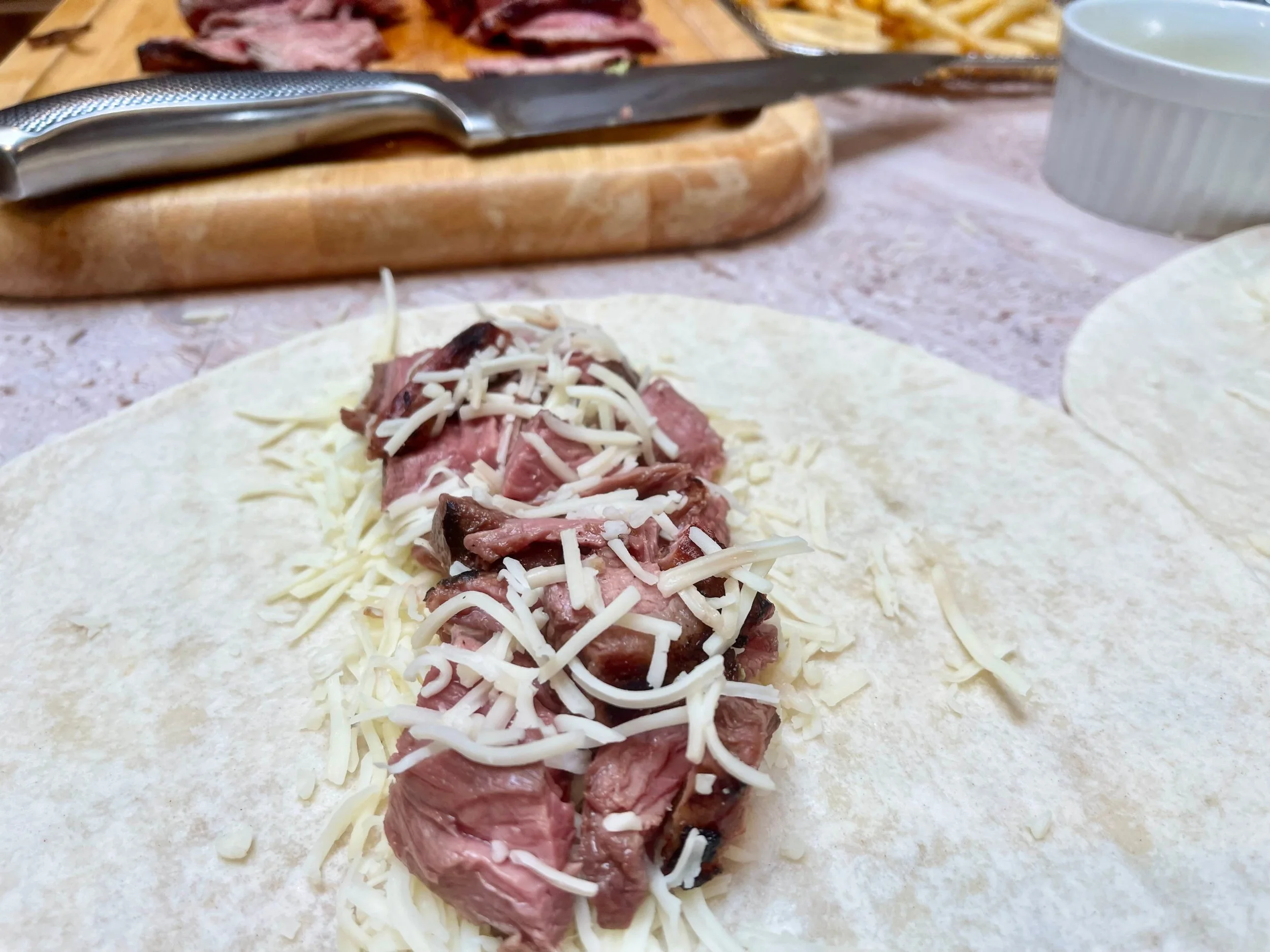 Carne asada and cheese on warmed tortilla