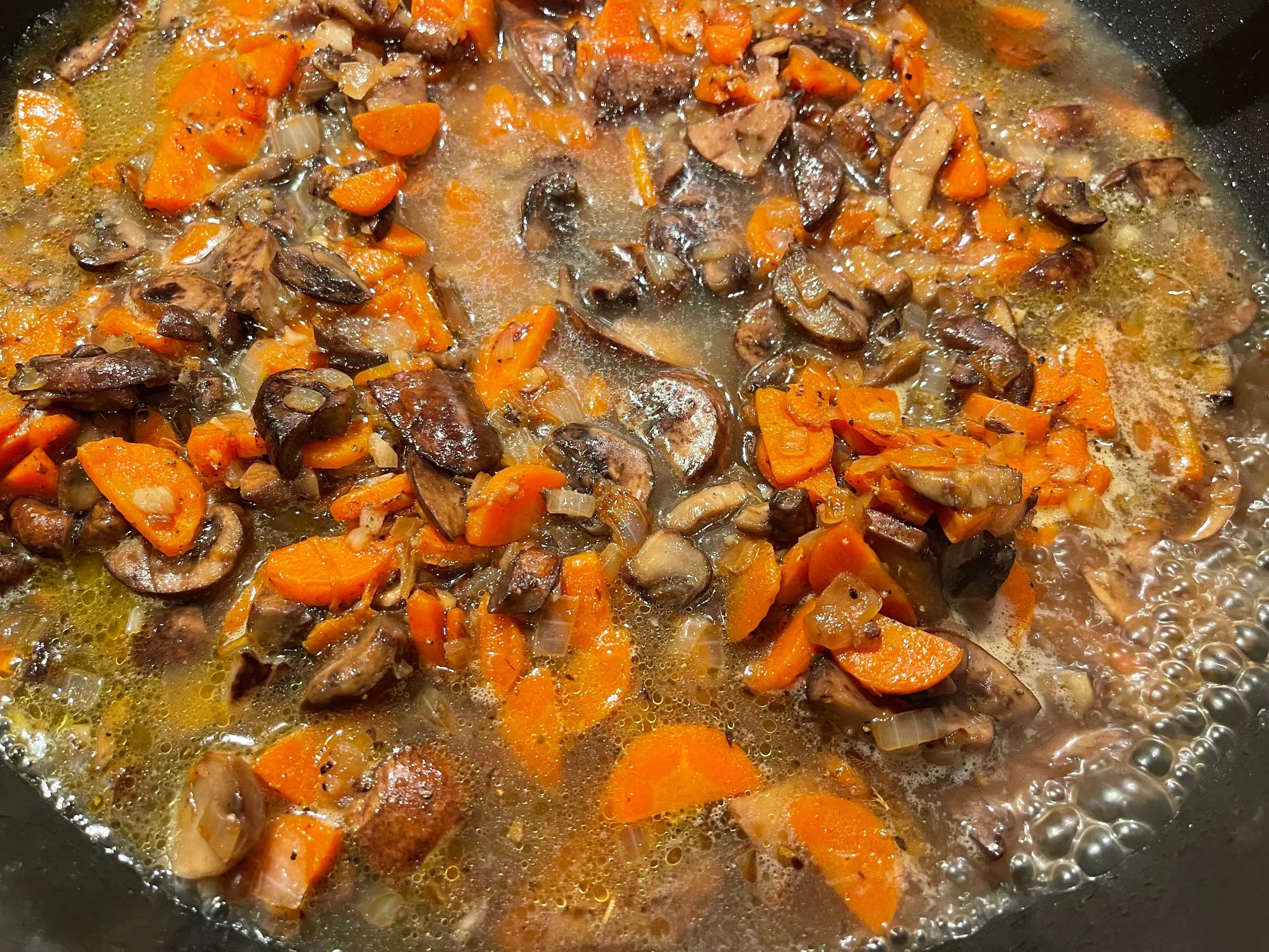 Adding chicken broth to make the cacciatore sauce
