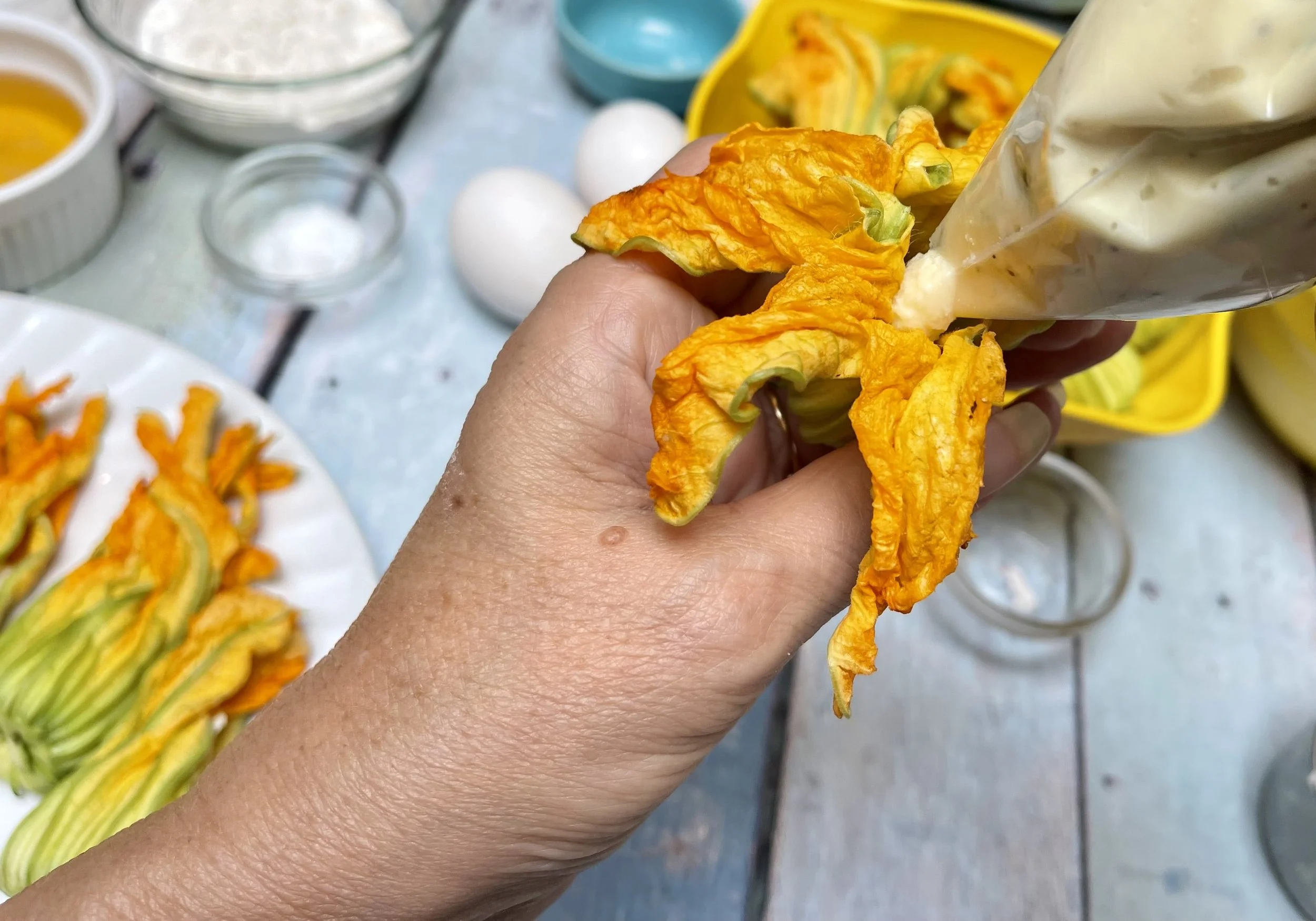 Piping the cheese mixture into a flower with a baggie