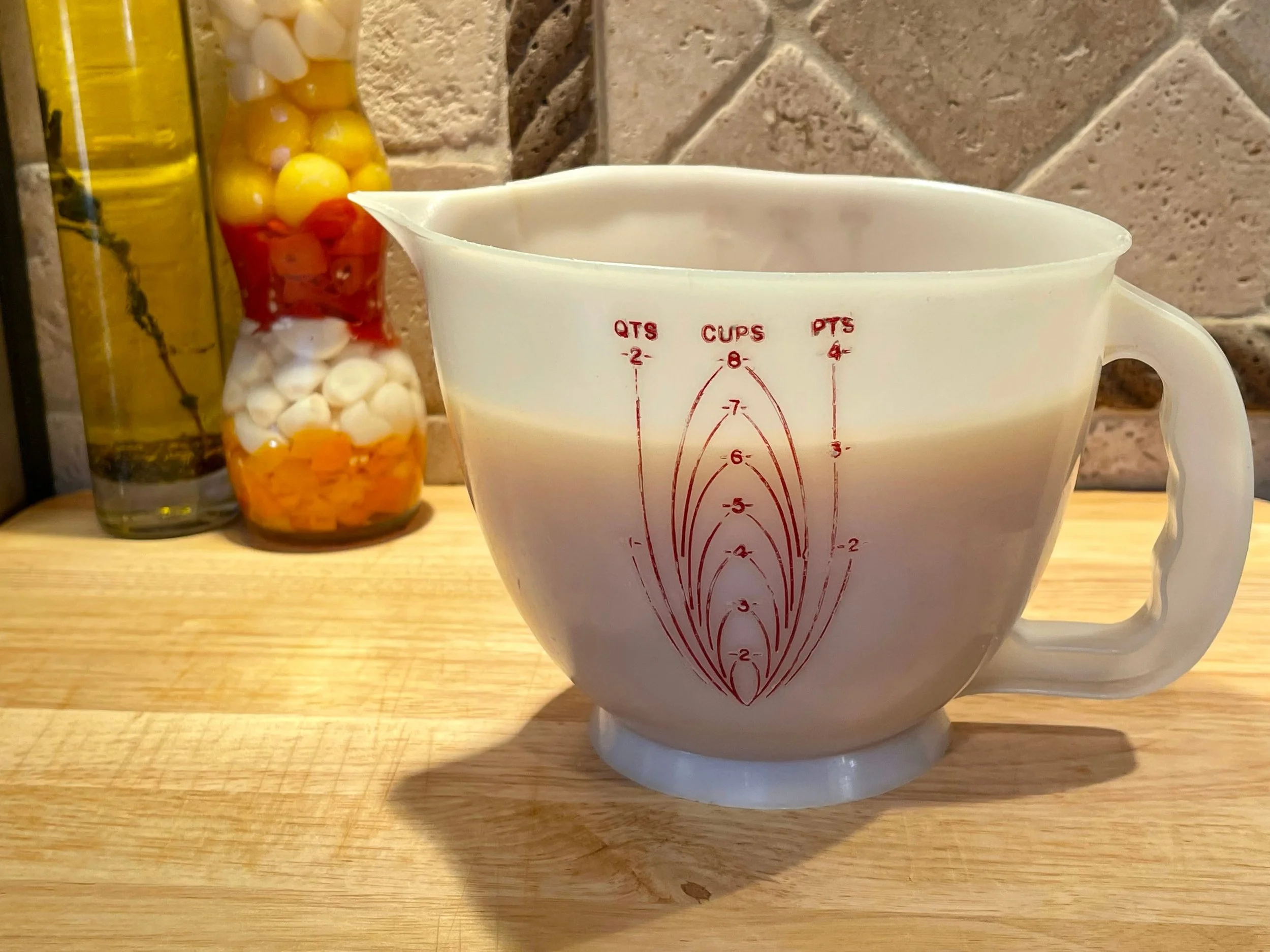 cooling the strained chicken stock in a large pitcher