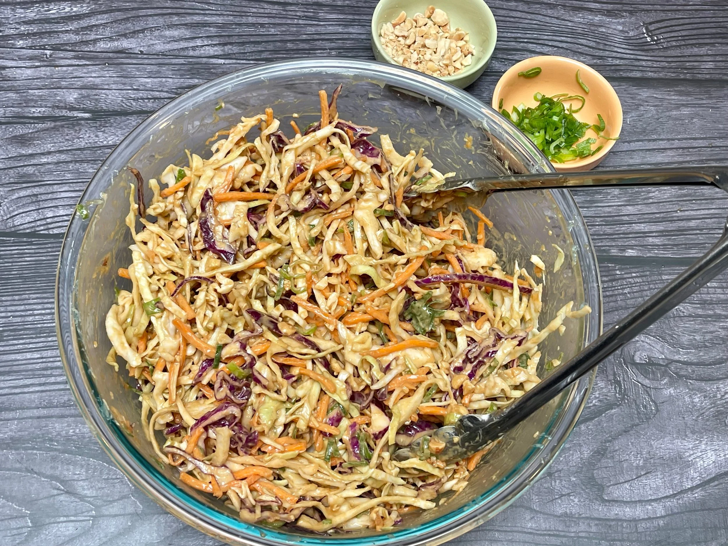 Mixing the peanut dressing with the slaw
