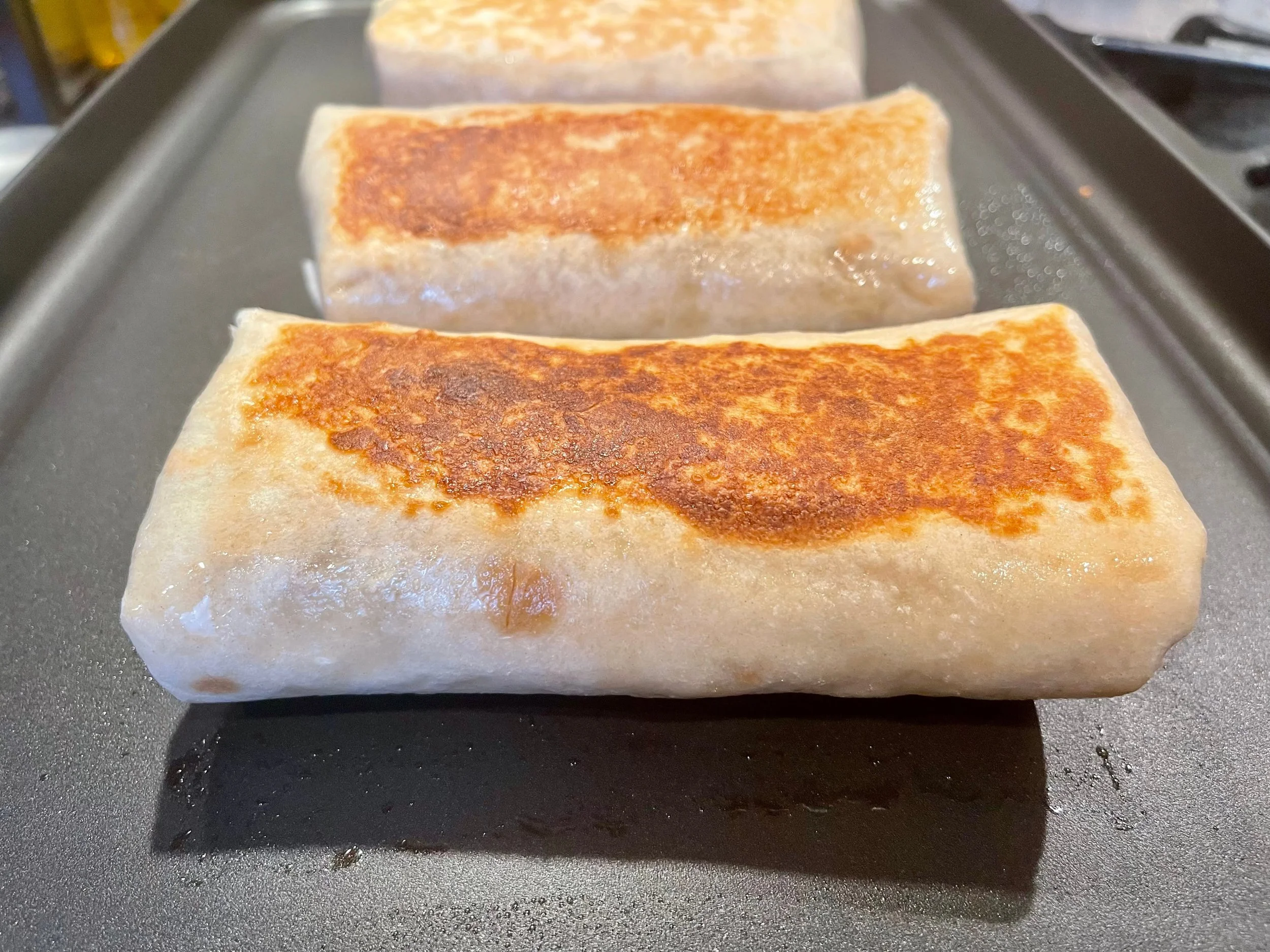 Searing California Burritos on a griddle