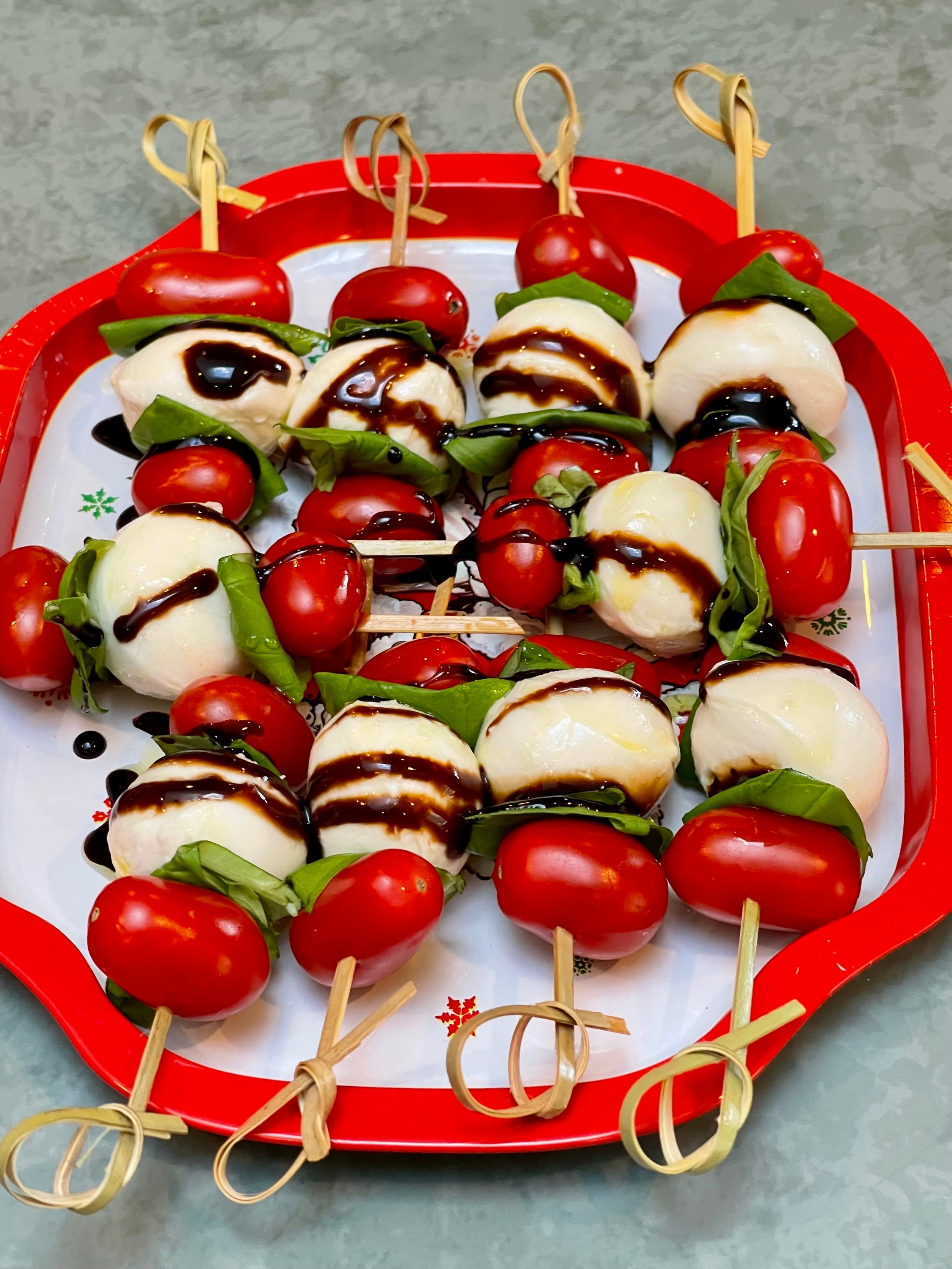 Balsamic glaze drizzled on Caprese Sticks
