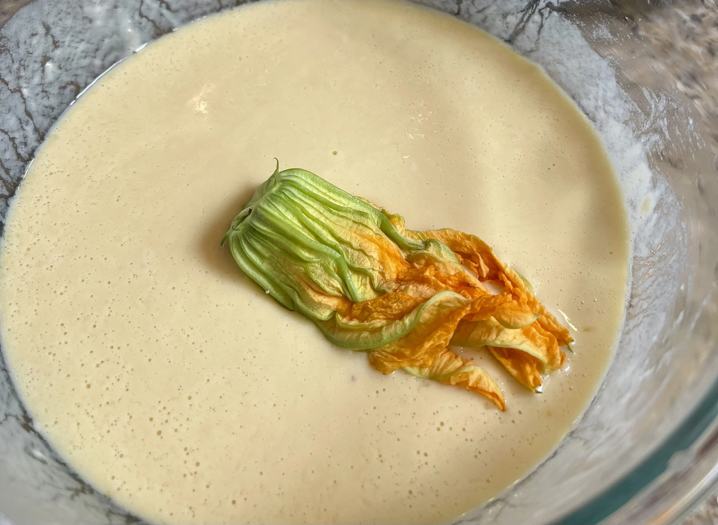 dredging a stuffed blossom in the batter