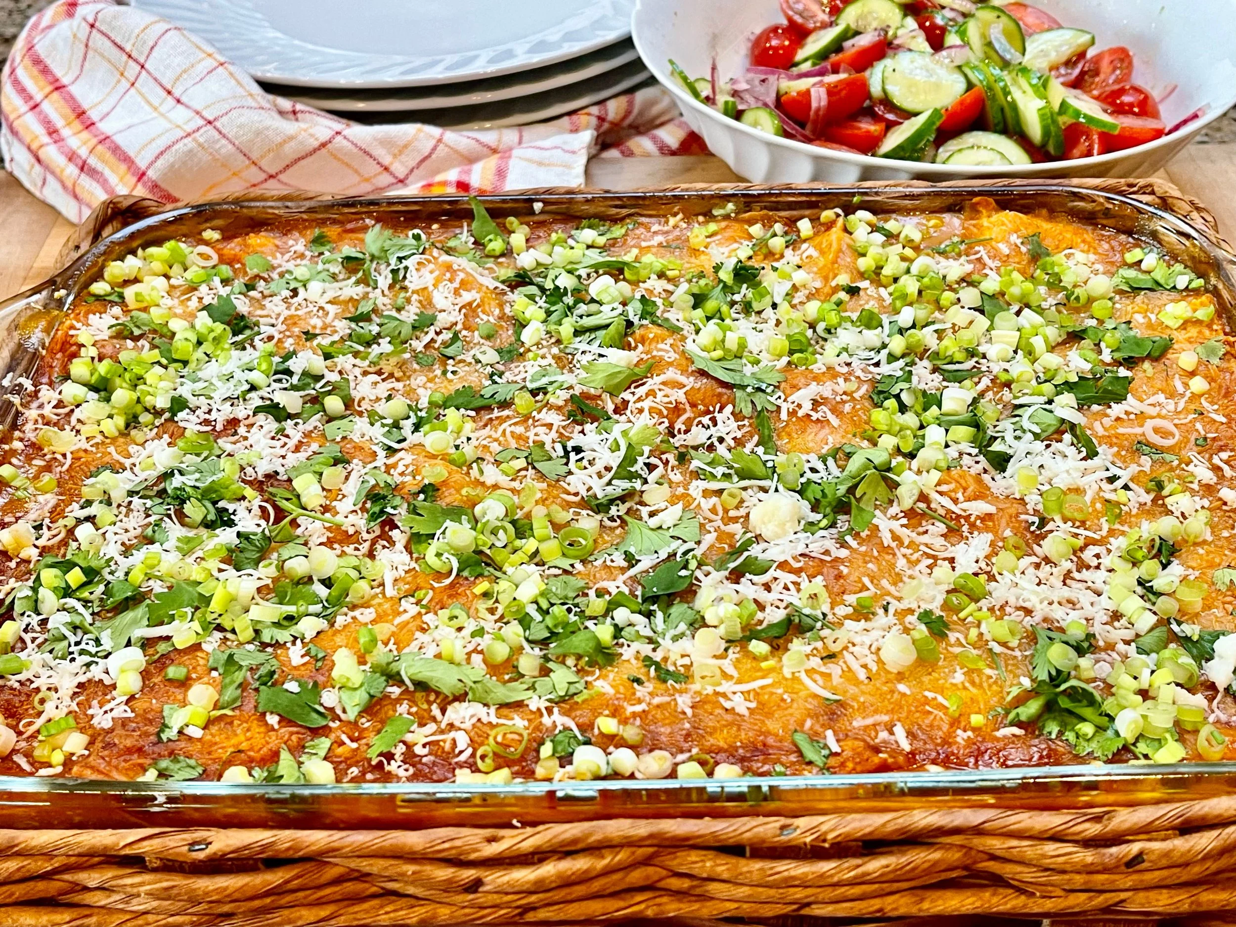 Chicken Enchilada Casserole, plates and salad in back