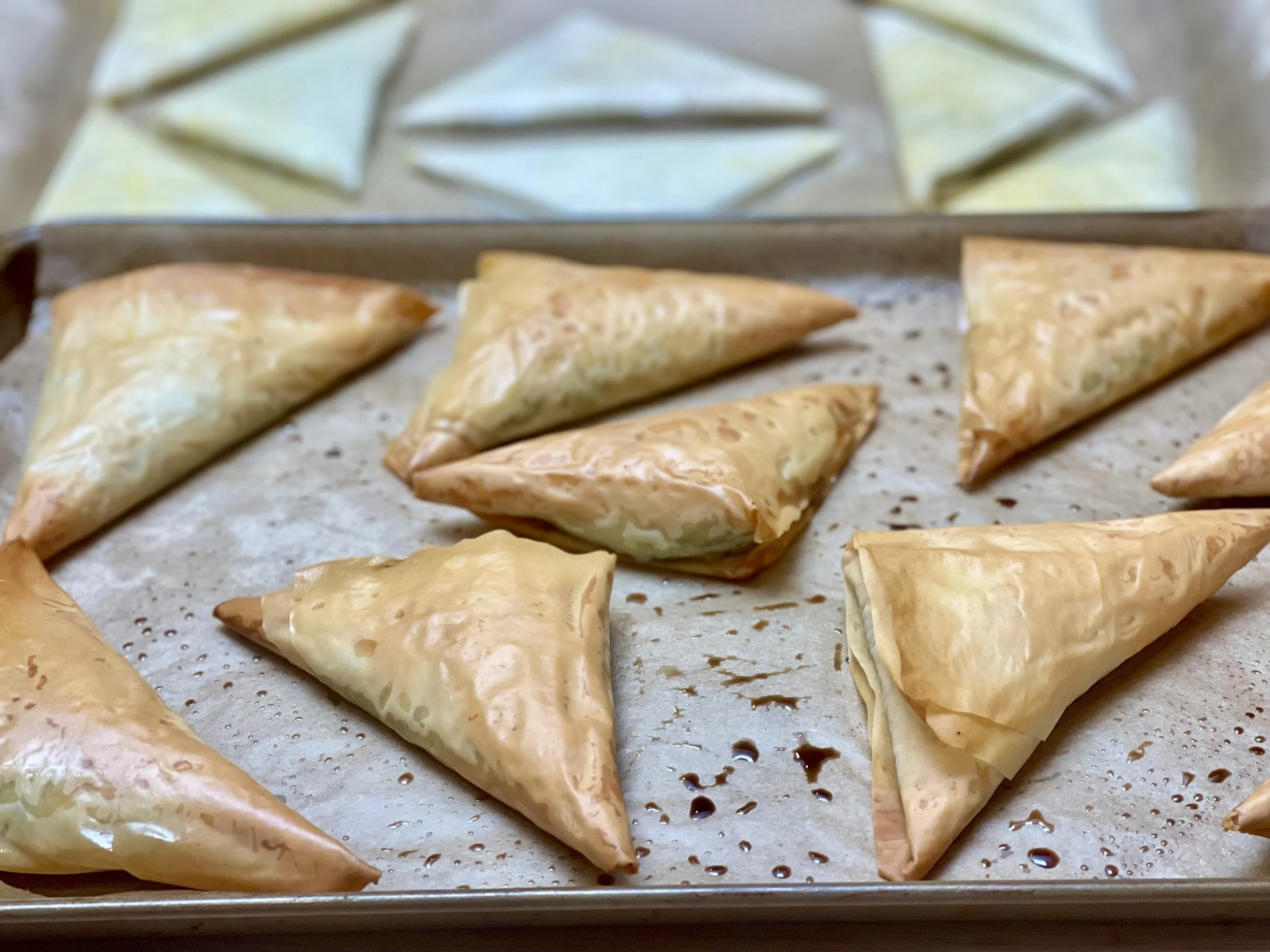 Golden brown spanakopita triangles