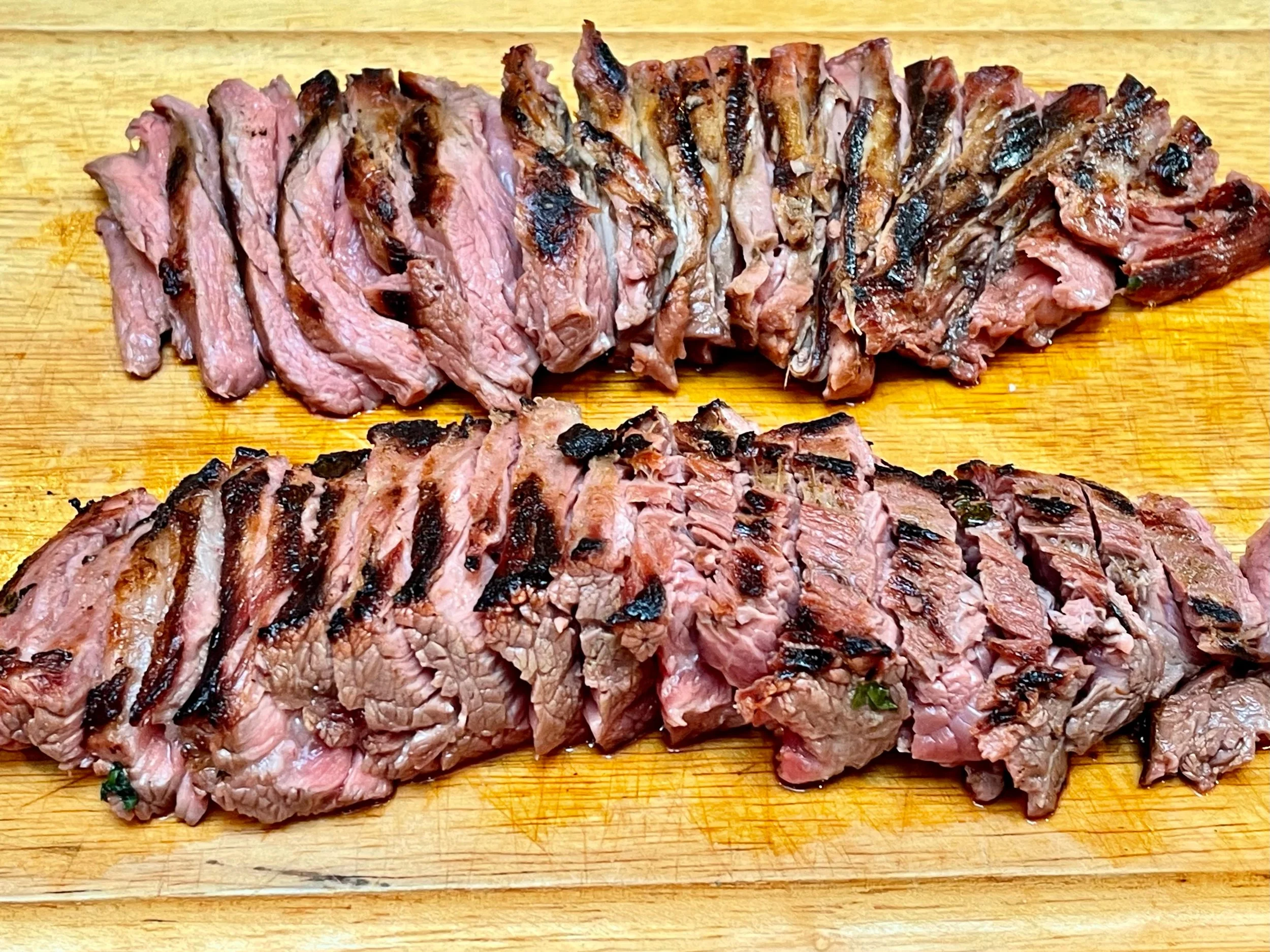 Sliced carne asada on cutting board