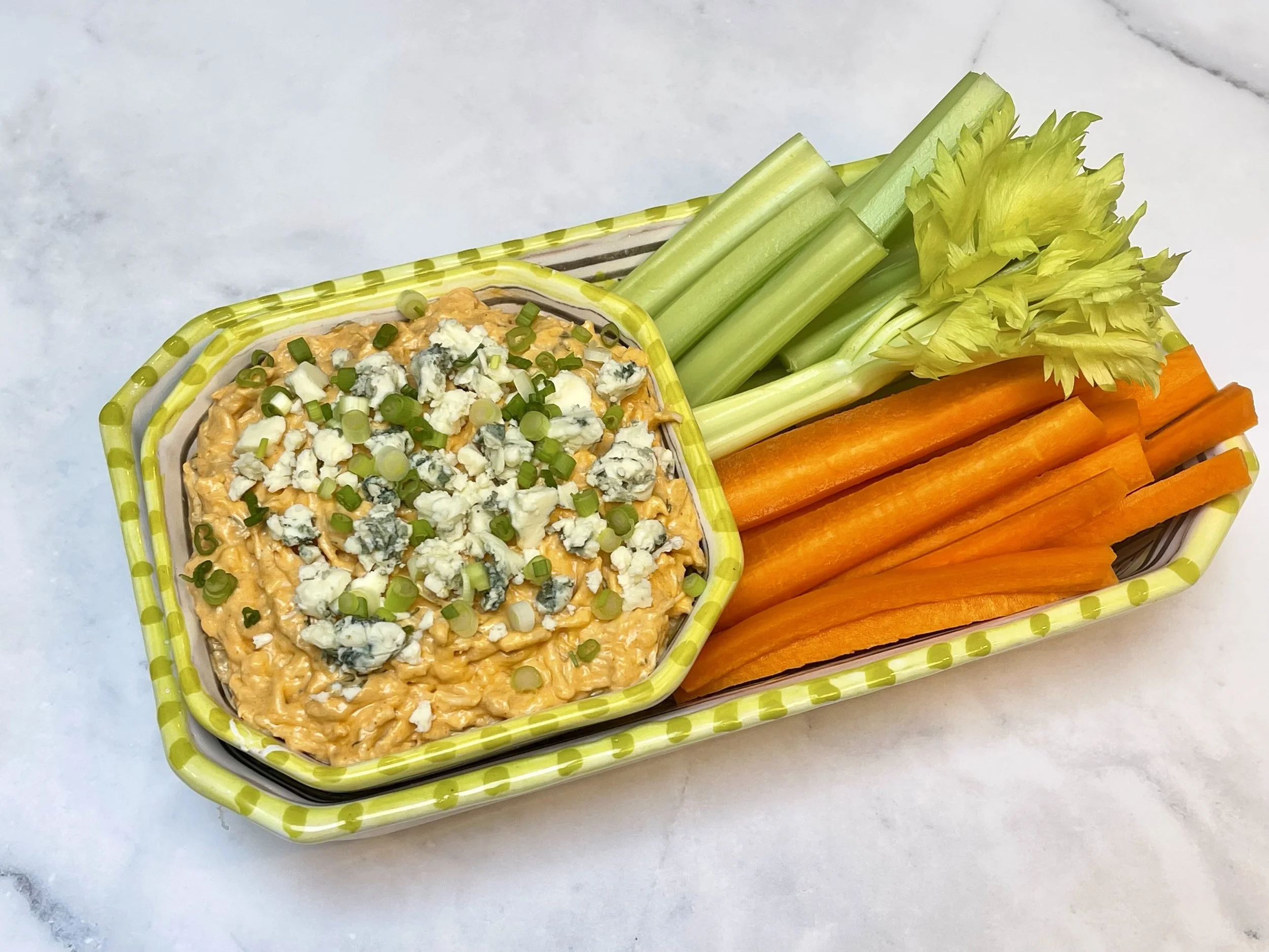 Cold Buffalo chicken dip with carrots and celery
