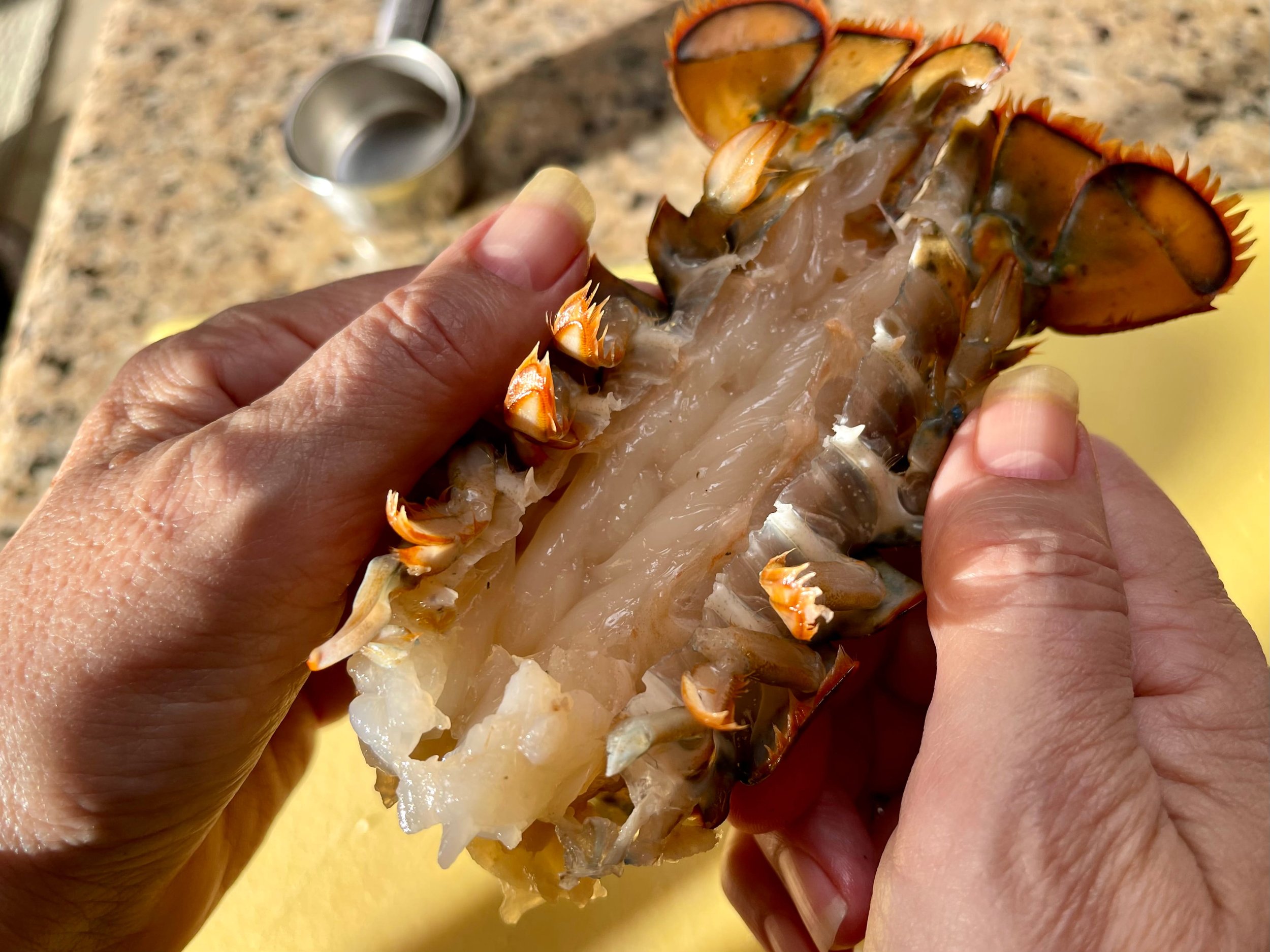 Removing the shells from the lobster tails