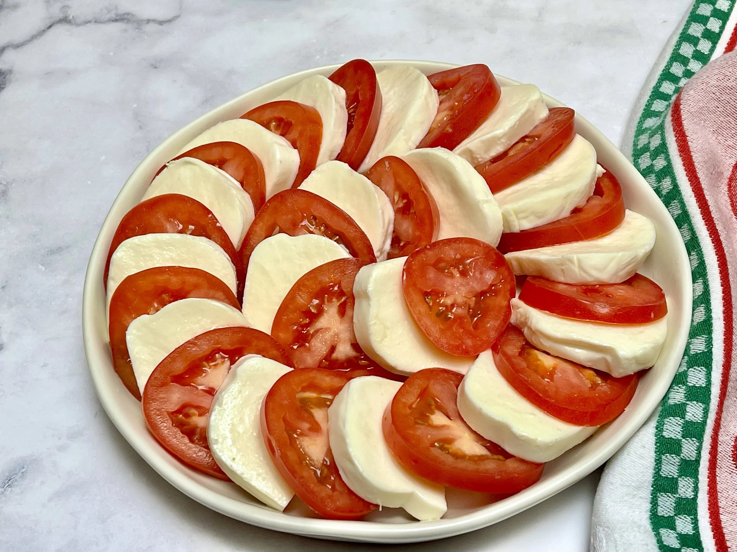 EVOO drizzled and salt sprinkled on the tomatoes and cheese