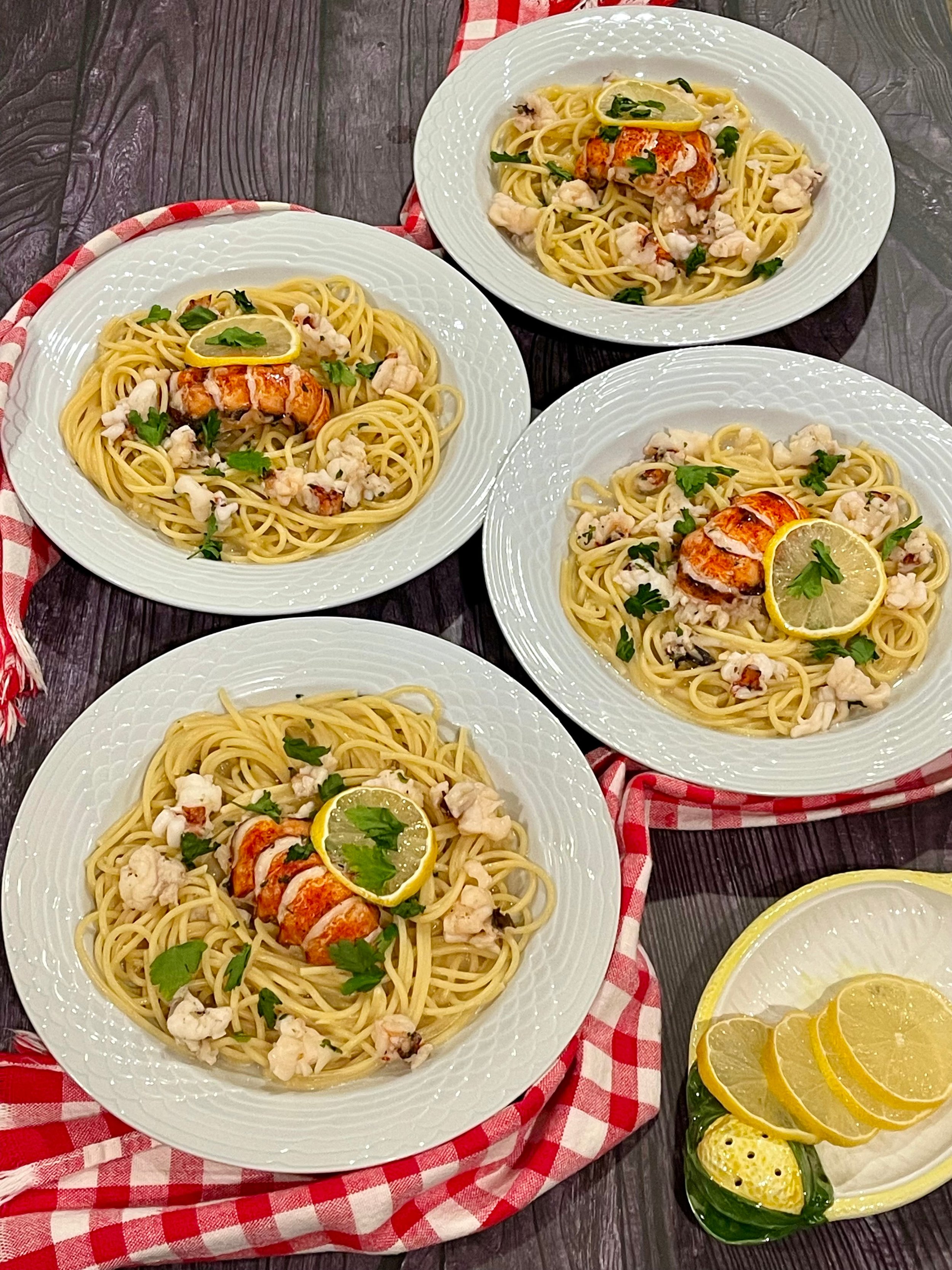 Lobster pasta garnished with lemon slices and parsley