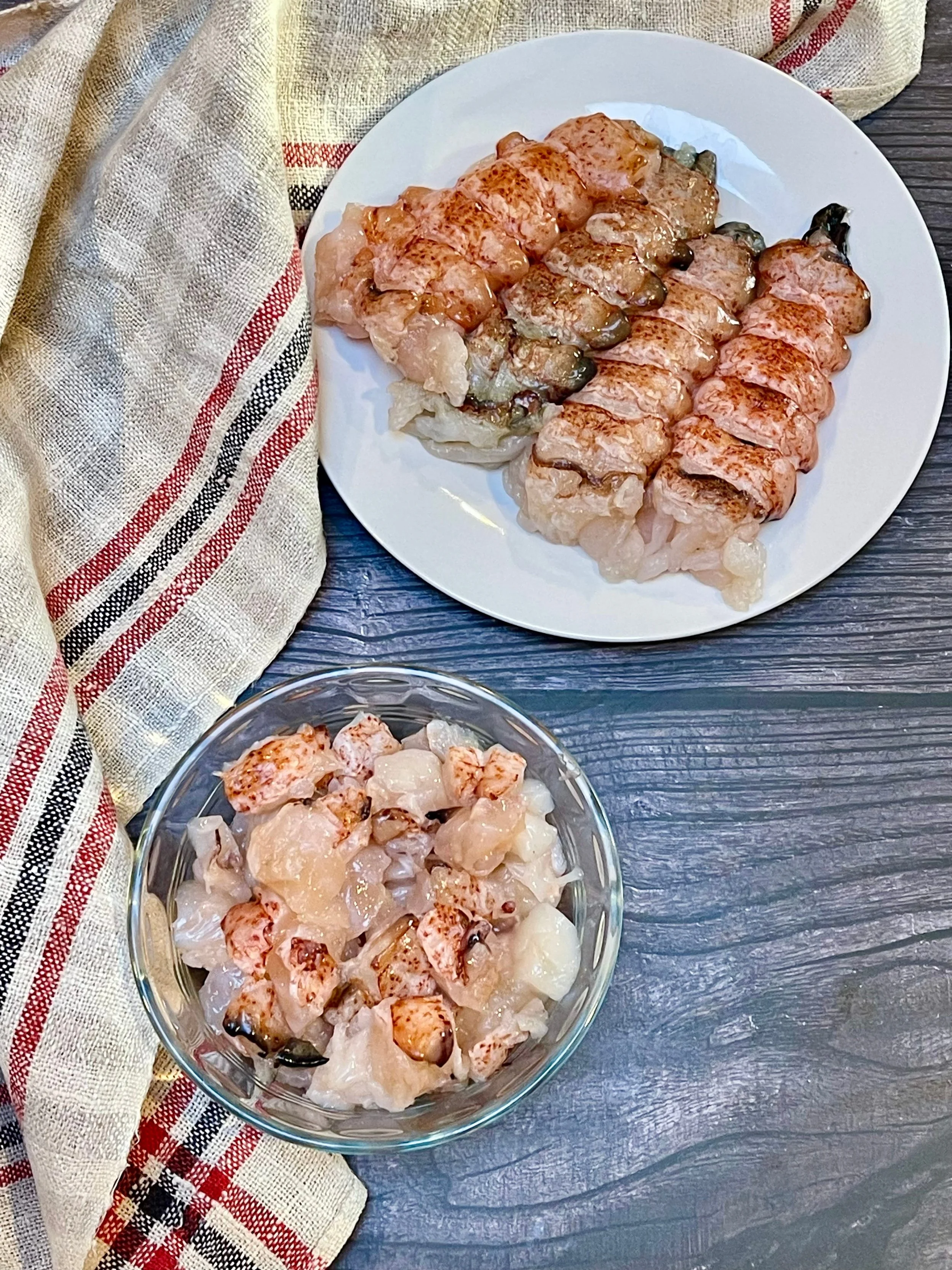 4 lobster tails and a bowl of cut lobster pieces