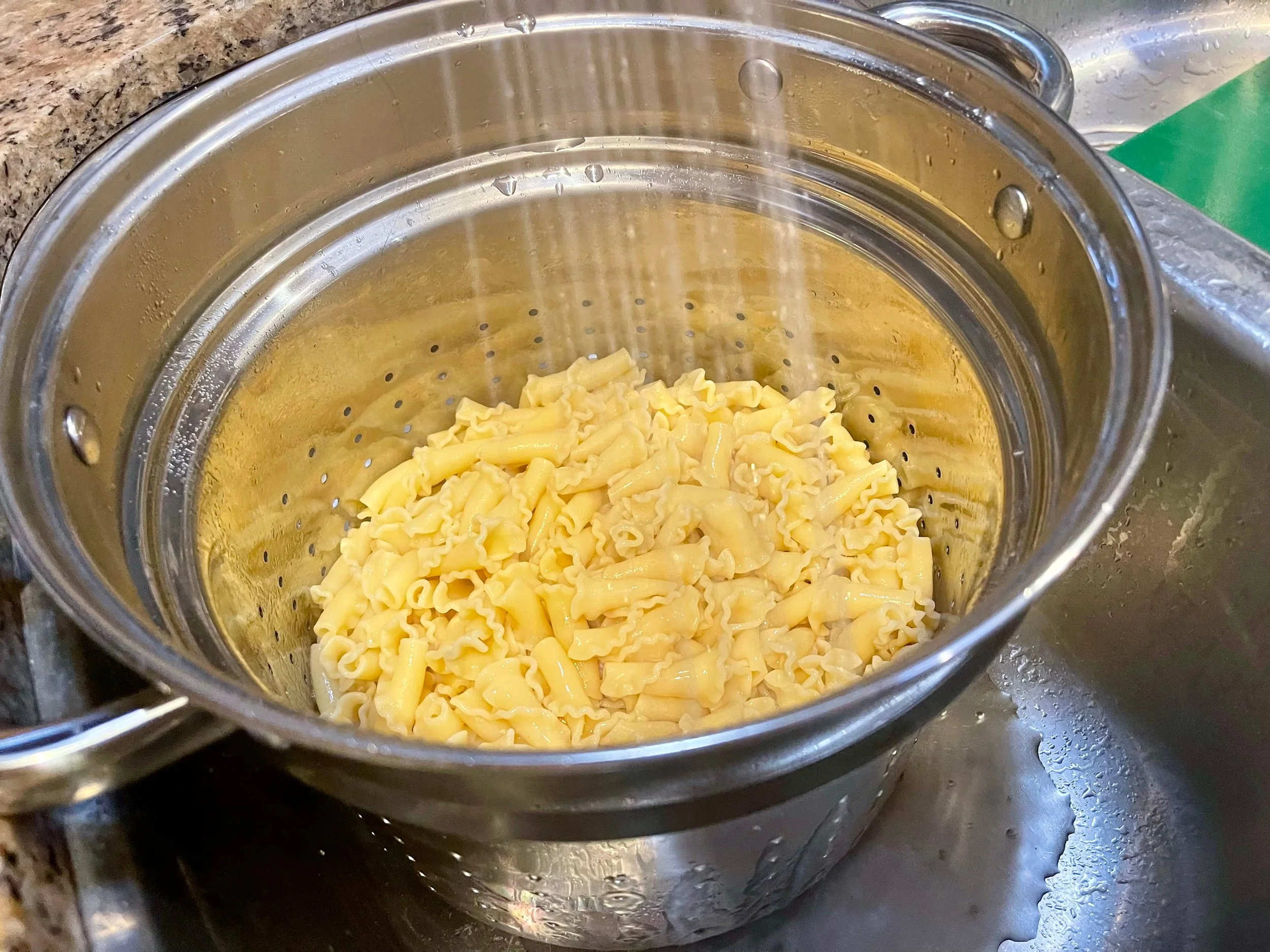 Rinsing pasta under cold water