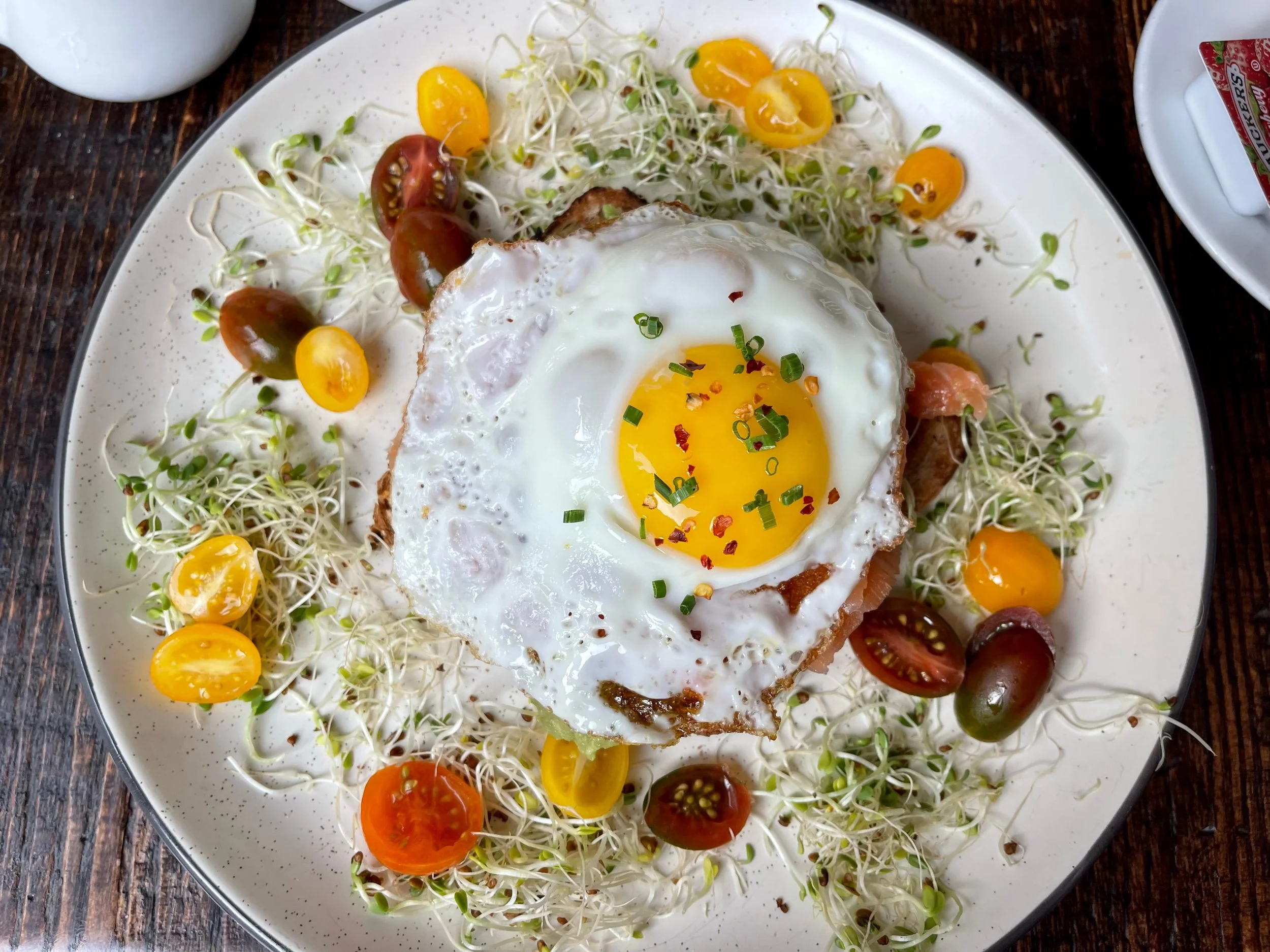Cherry tomatoes around an avocado toast