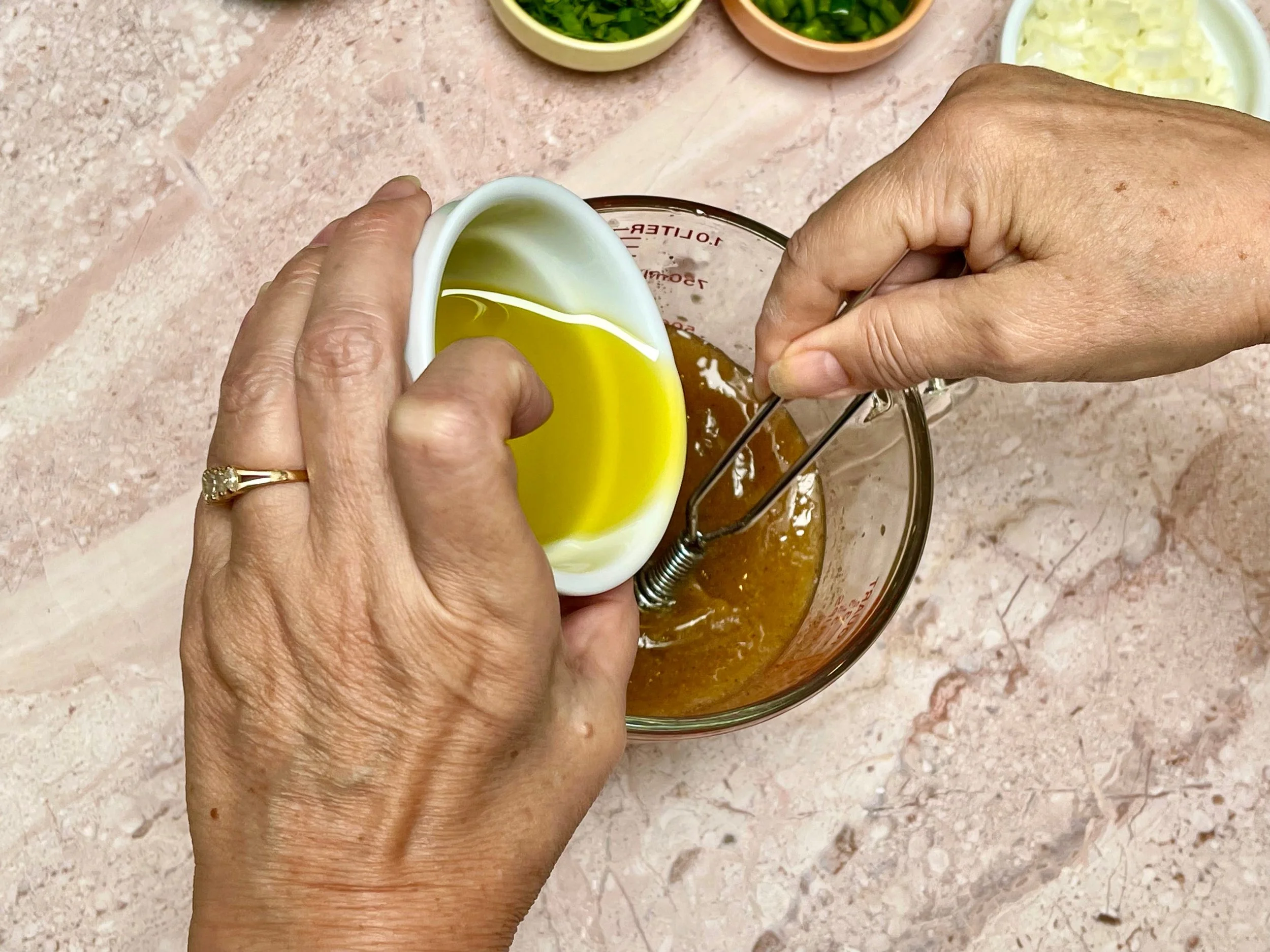 Whisking the olive oil into to carne asada marinade
