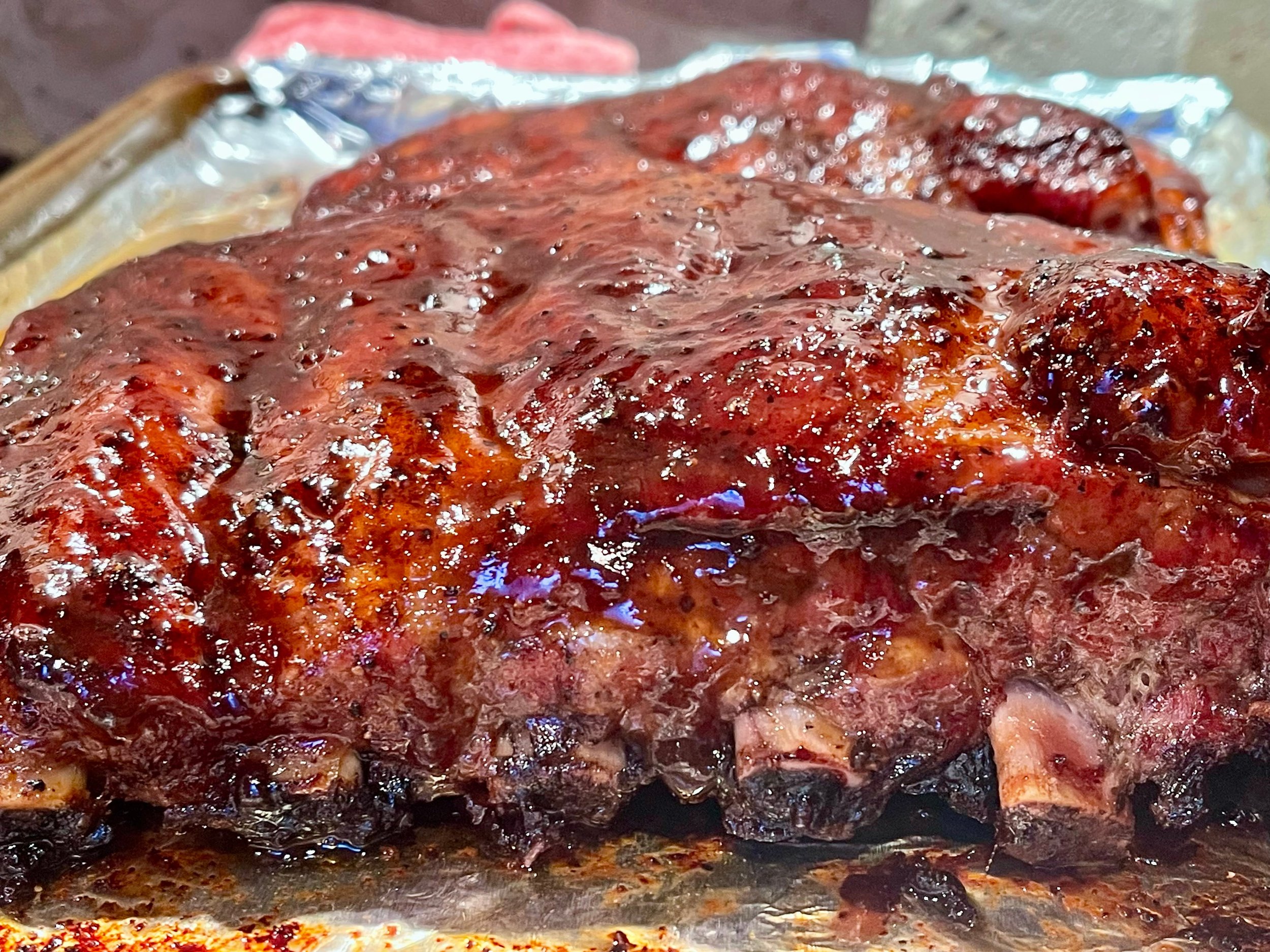 BBQ Sauce brushed on ribs before returning to the oven