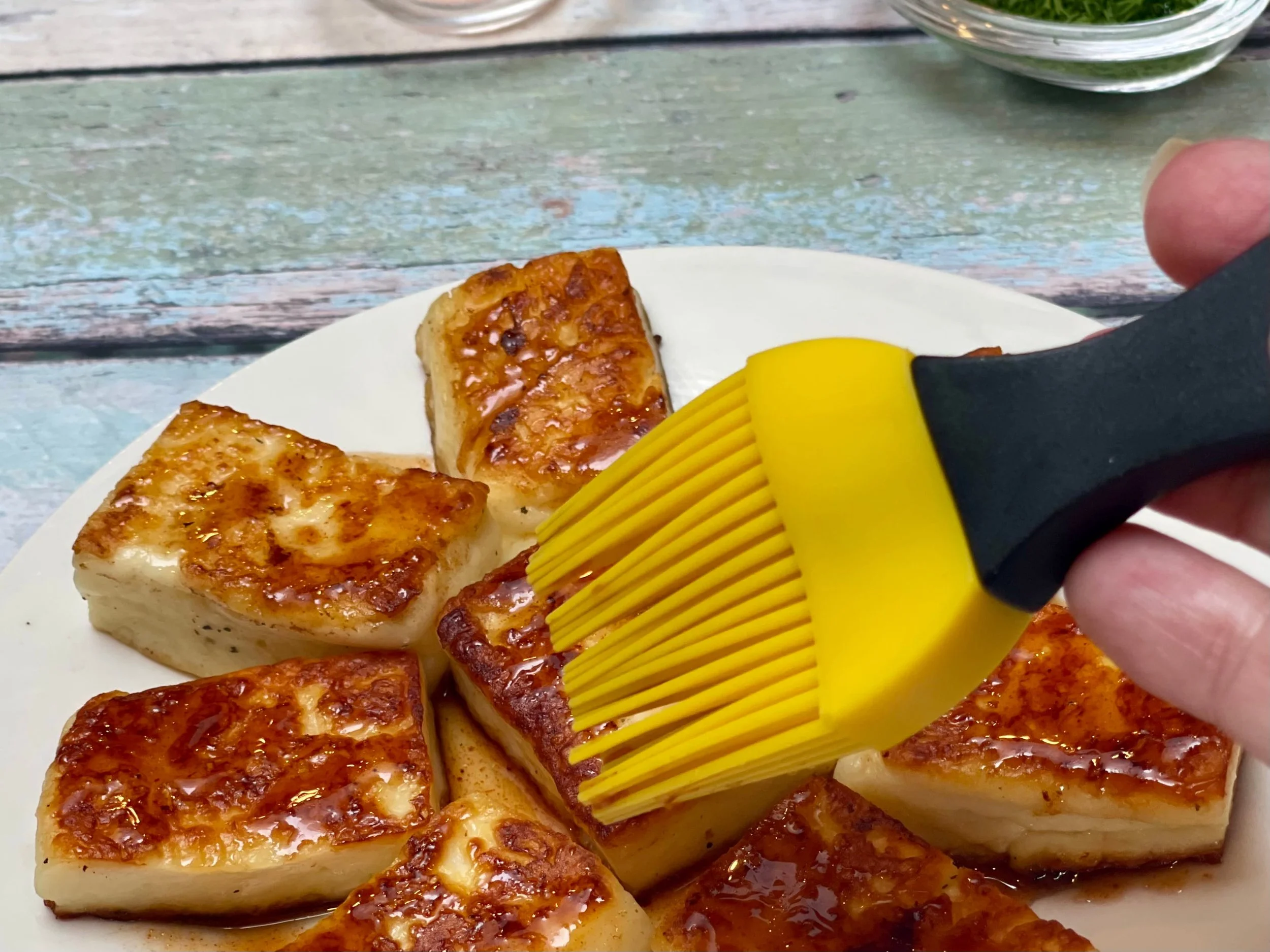 Coating the melty cheese with hot honey