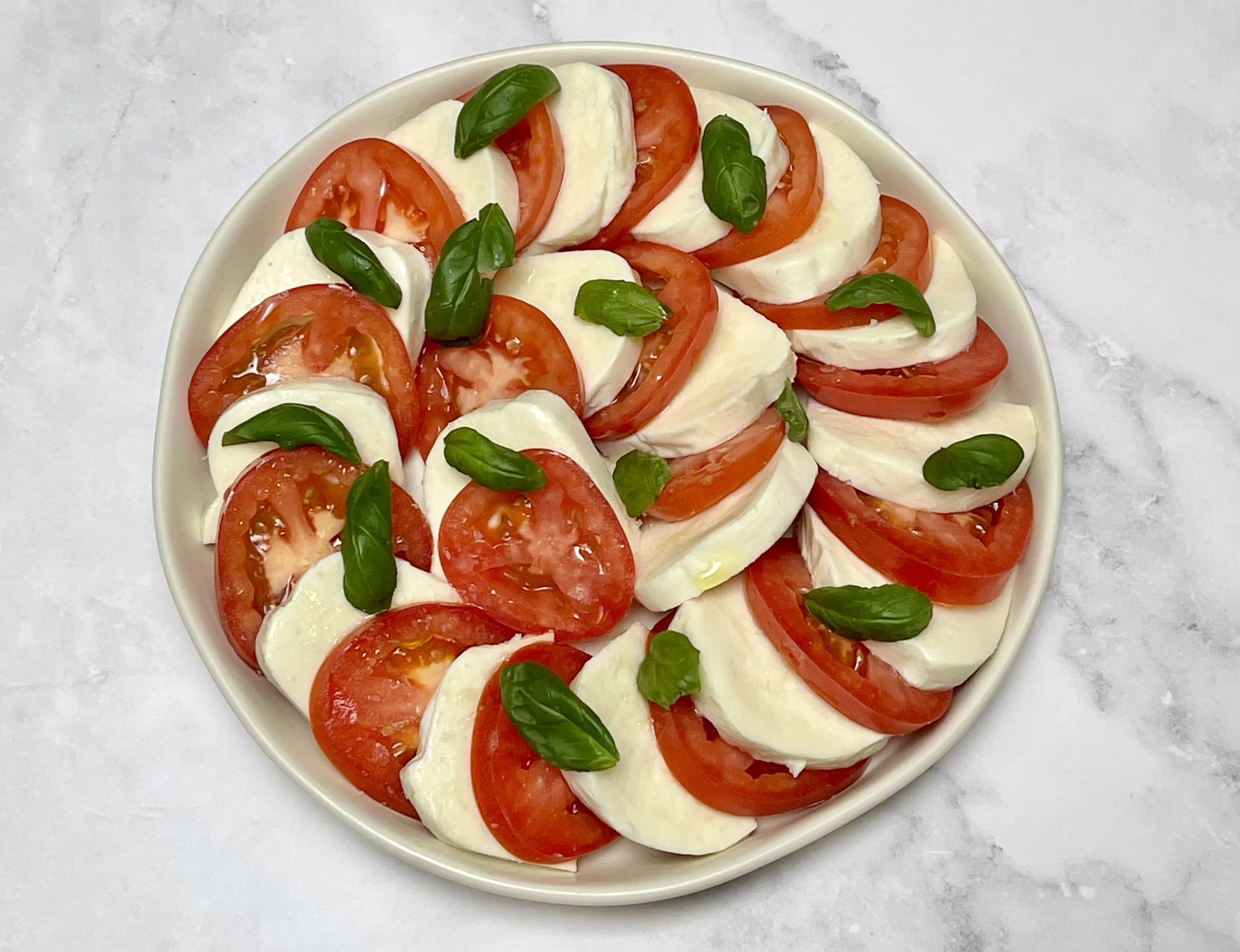 Basil added on top of the Caprese Salad