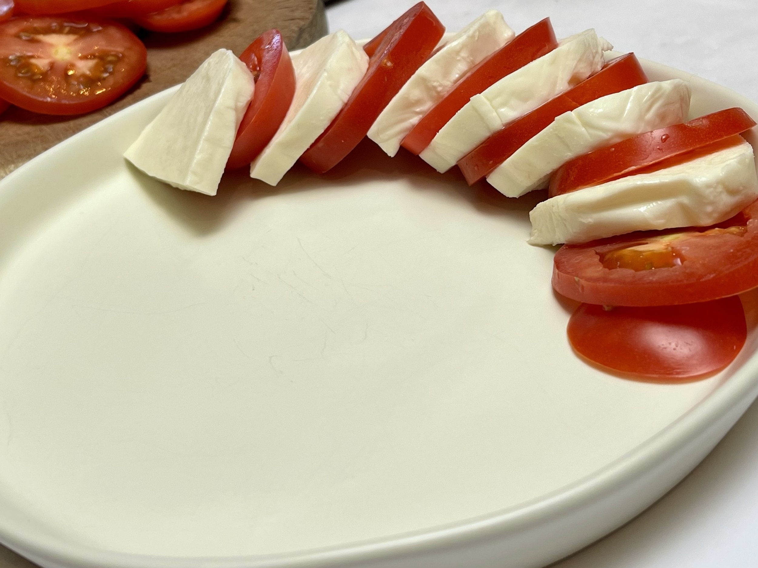 Arranging the cheese and tomatoes for Caprese salad
