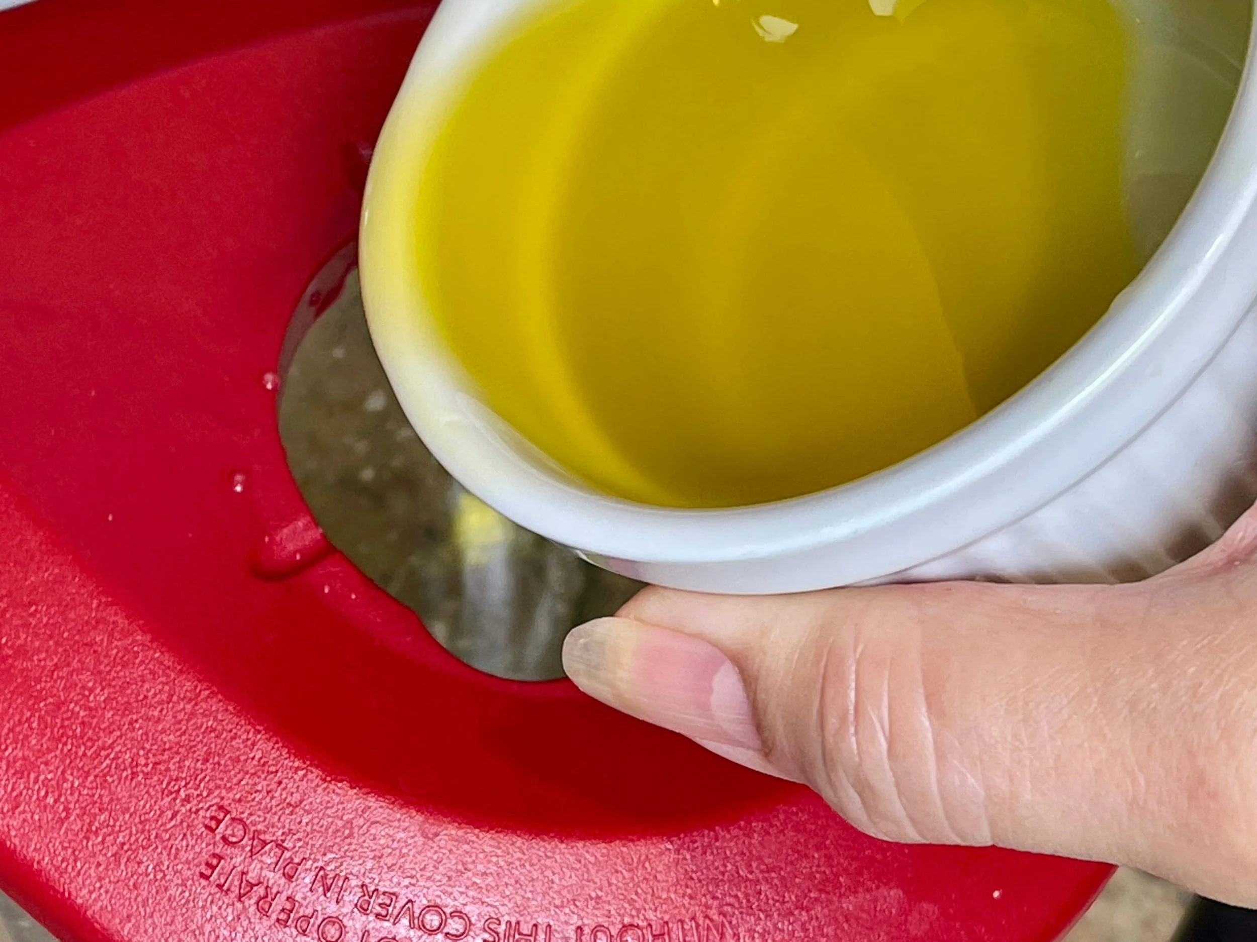 Step 2-slowly adding the EVOO
