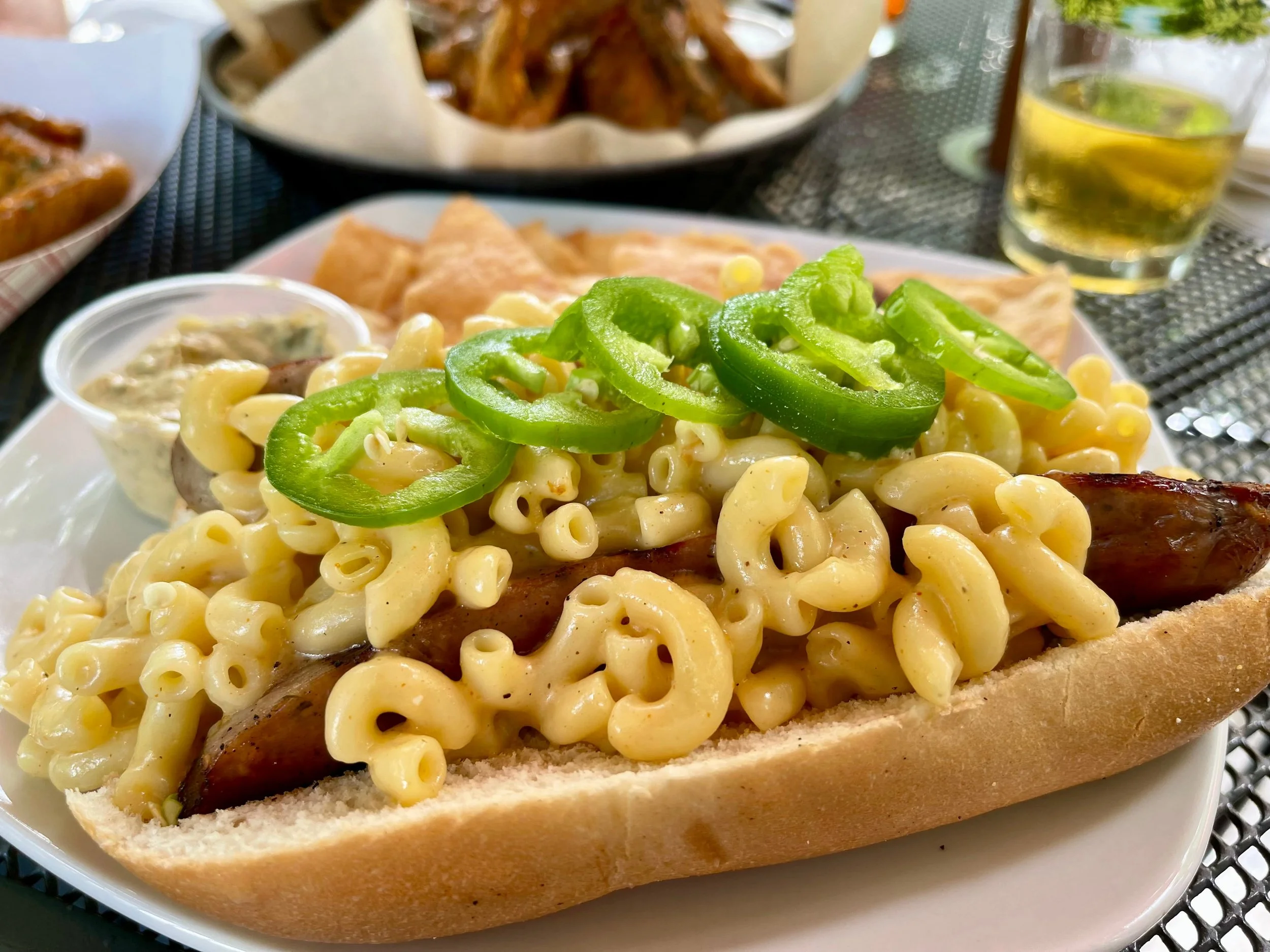 Mac and cheese on top of a hot dog