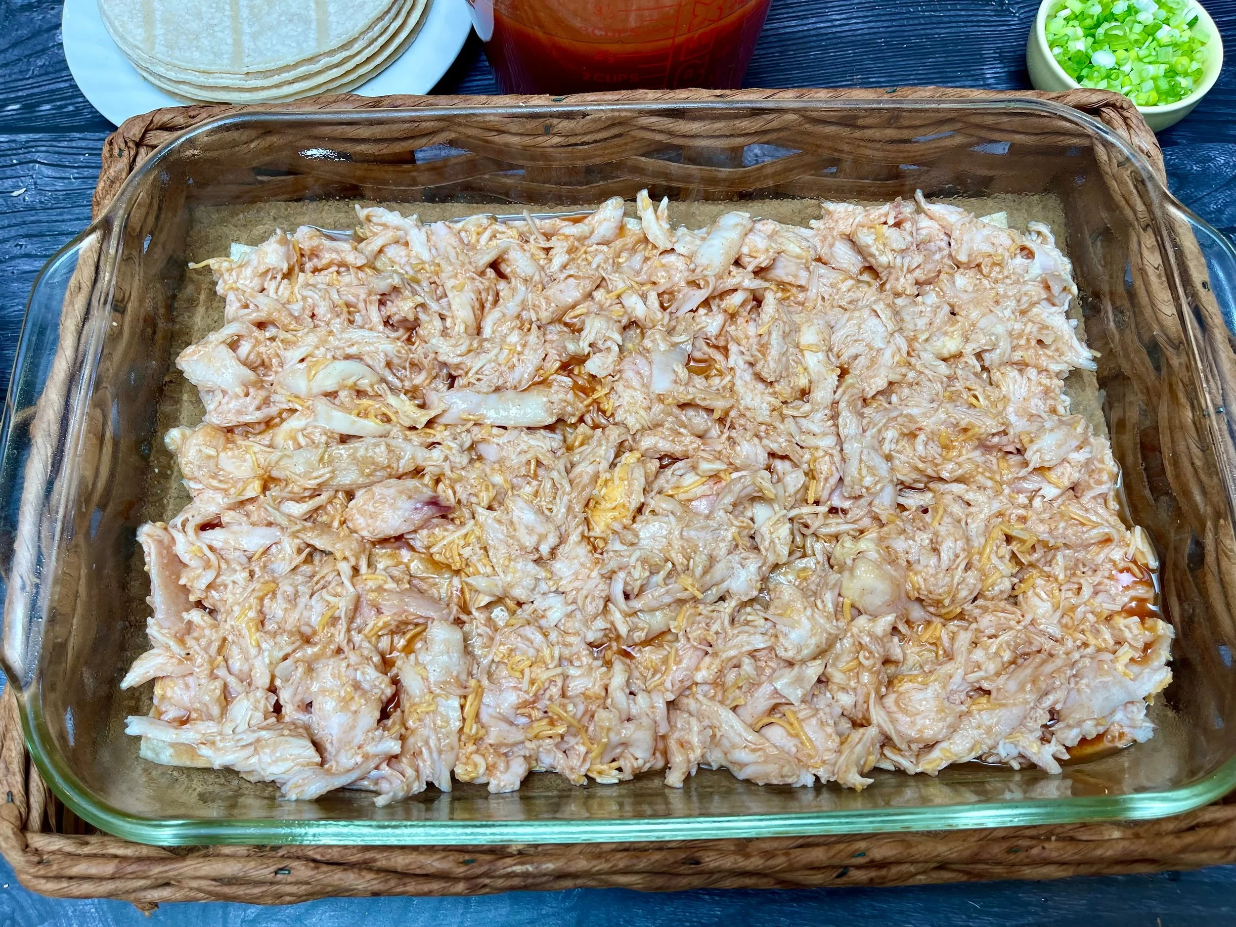 Layer of chicken over the enchilada sauce