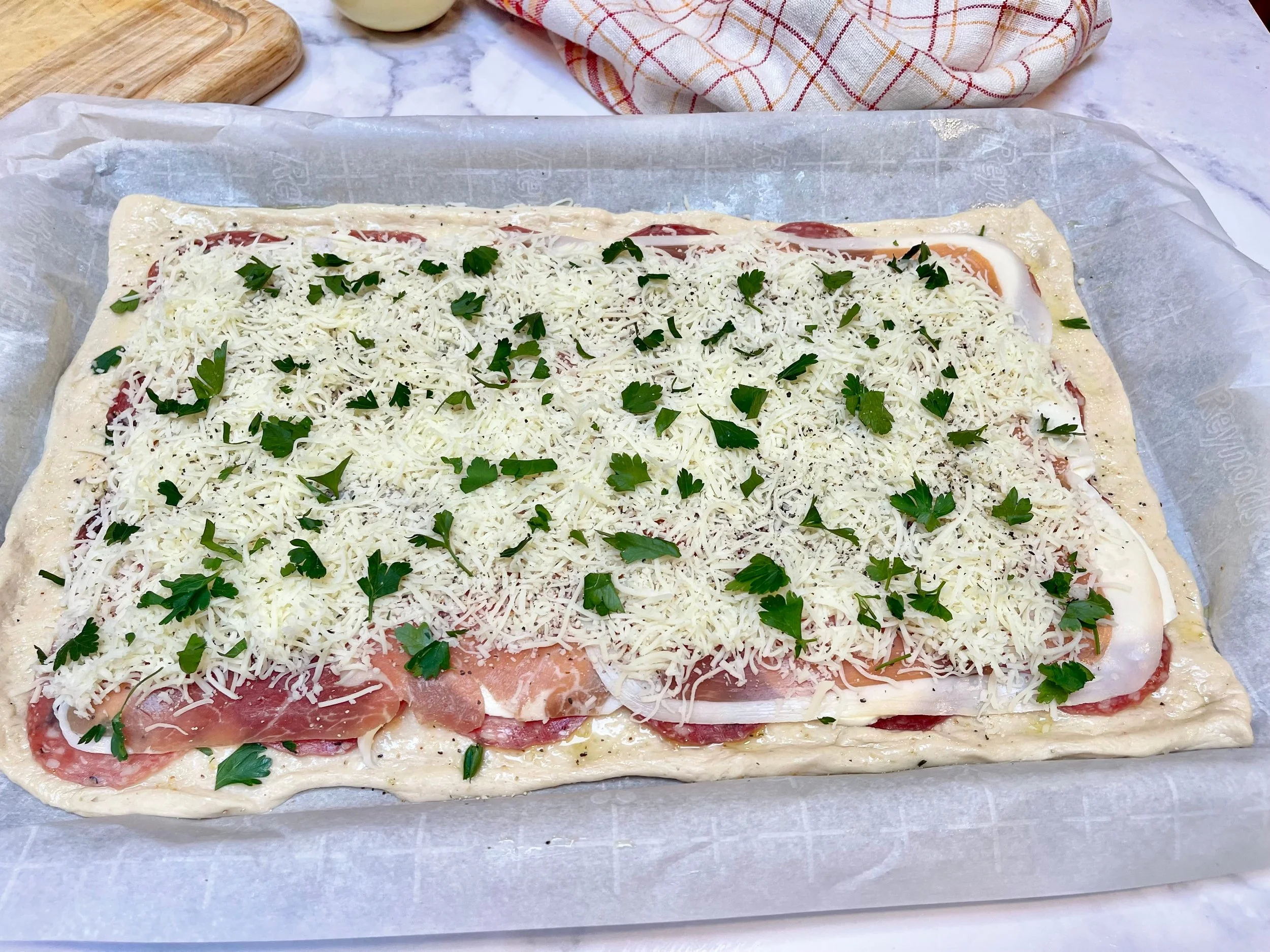 Stromboli filling: meats, cheeses, herbs, and seasonings layered