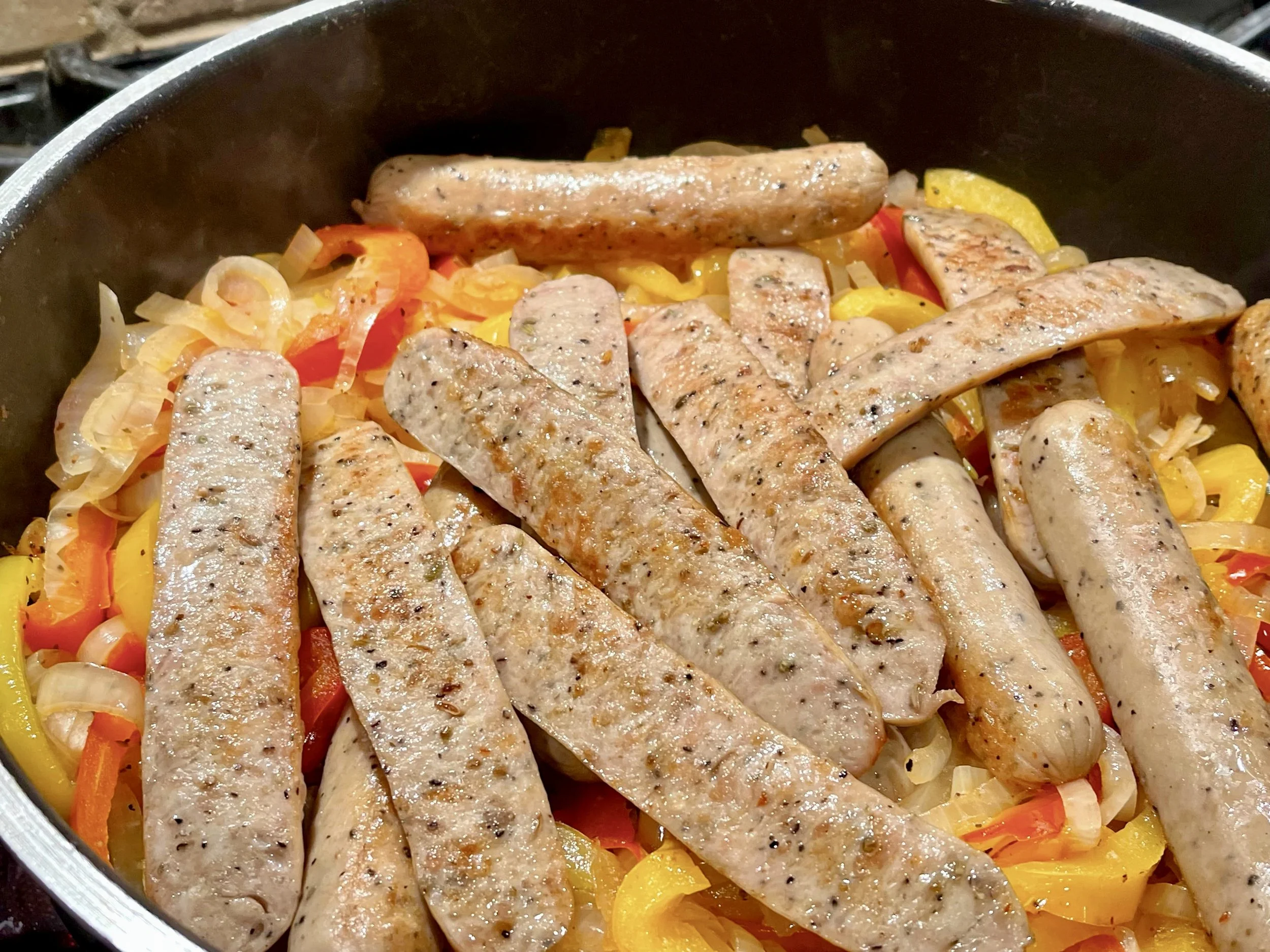 Sausages add to peppers and onions