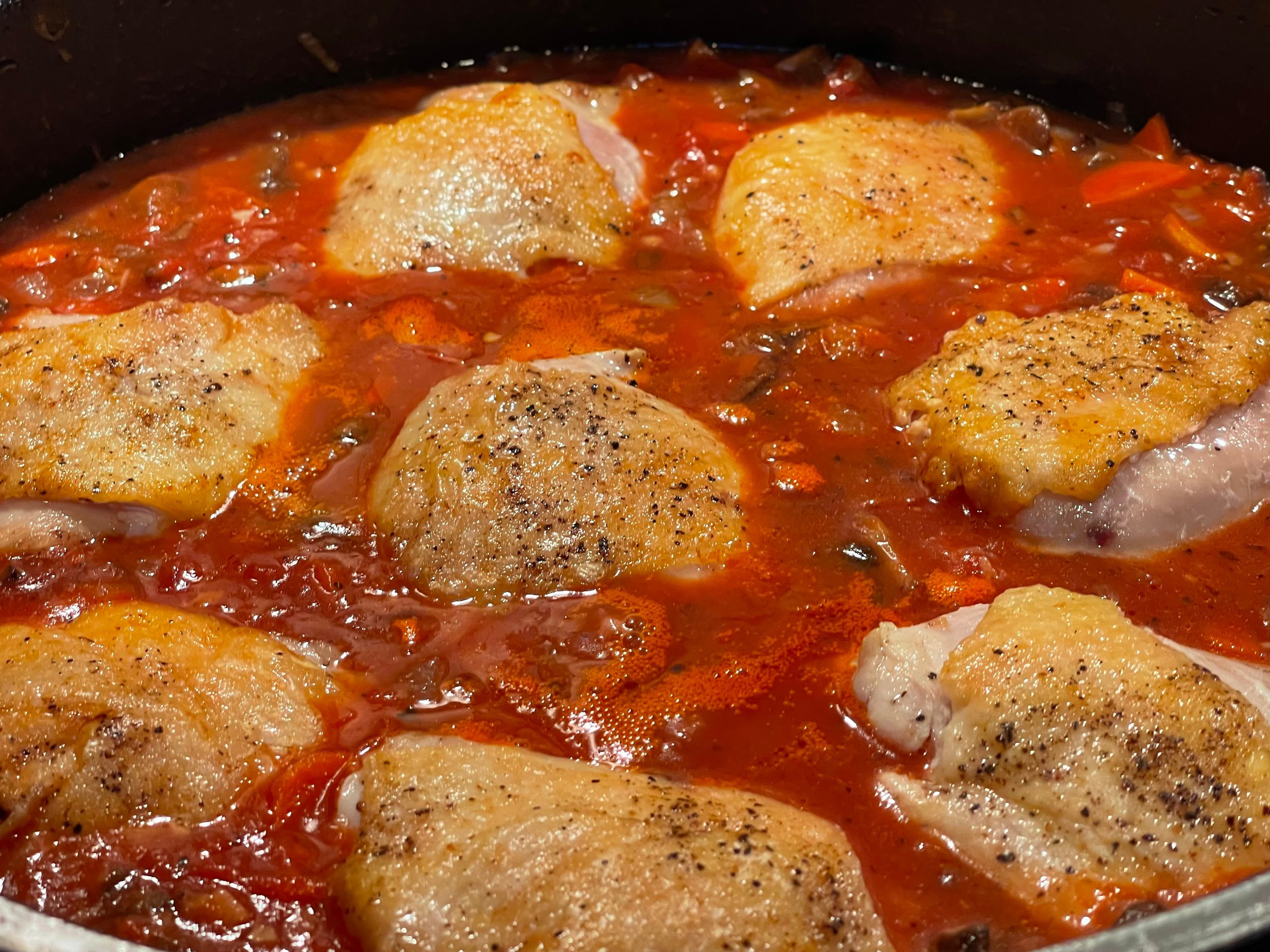 Braising the chicken in the cacciatore sauce
