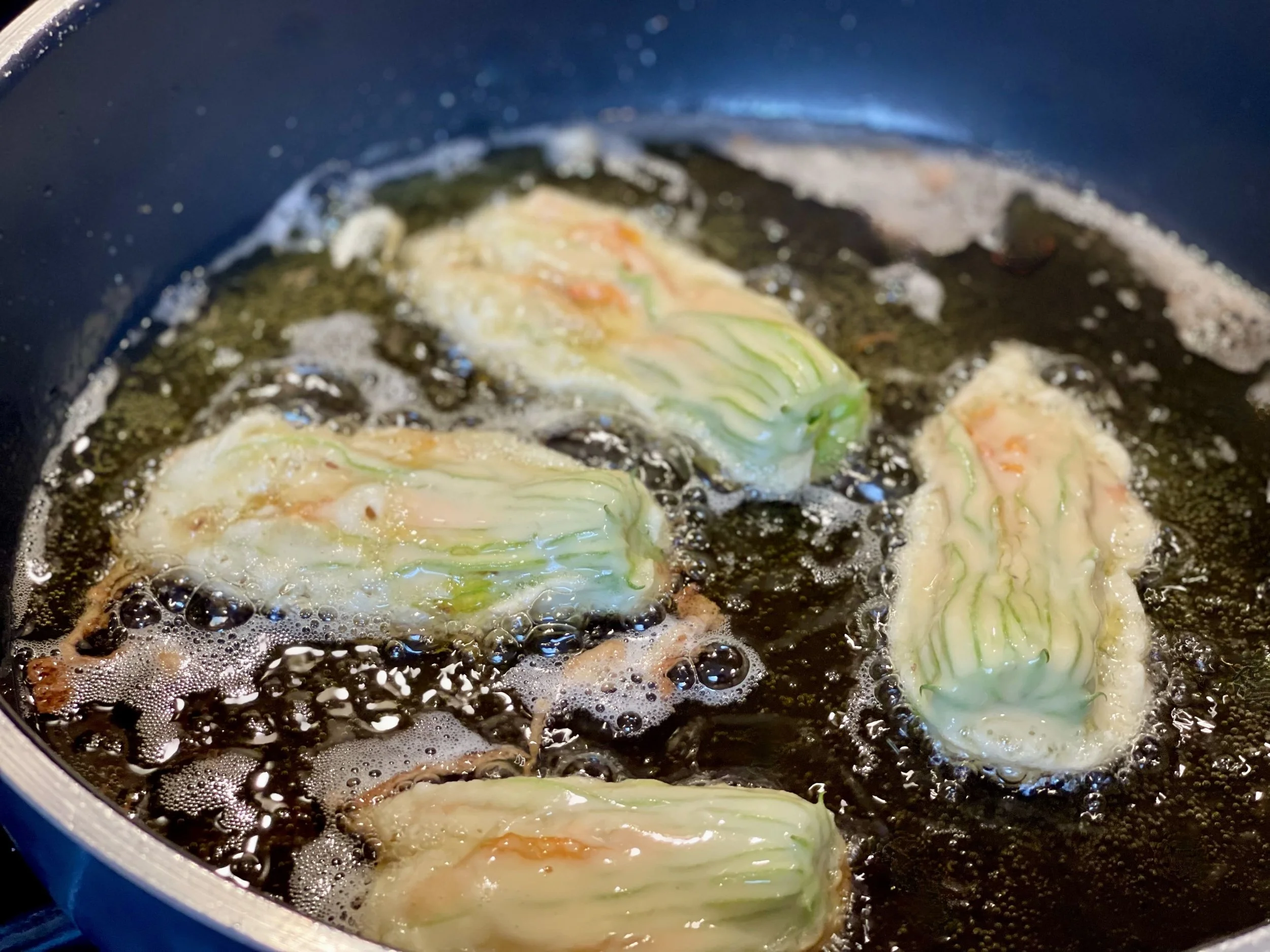 frying the zucchini blossoms