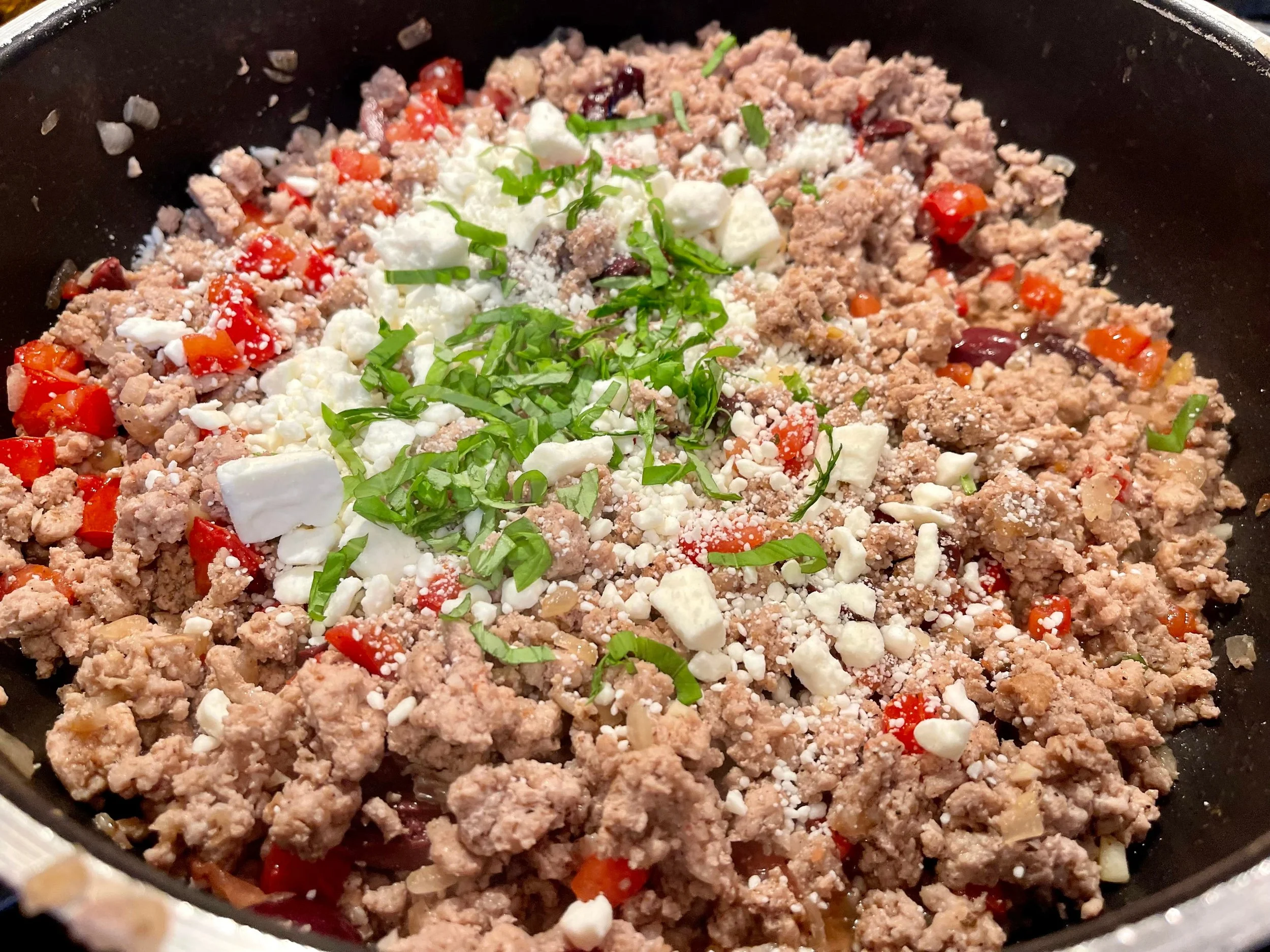 Adding feta and basil to meat filling